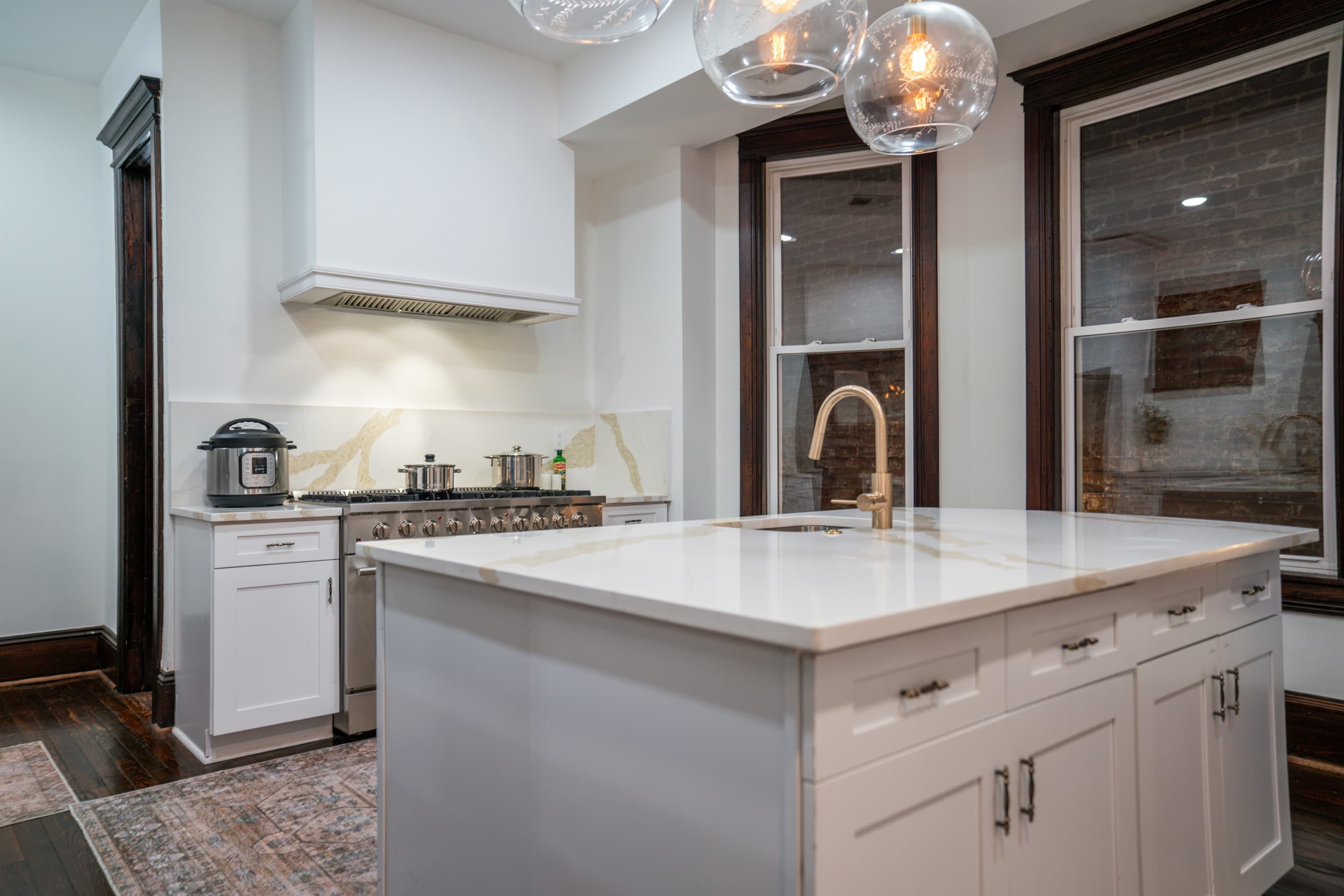 The kitchen features a large island in the center with seating on one side