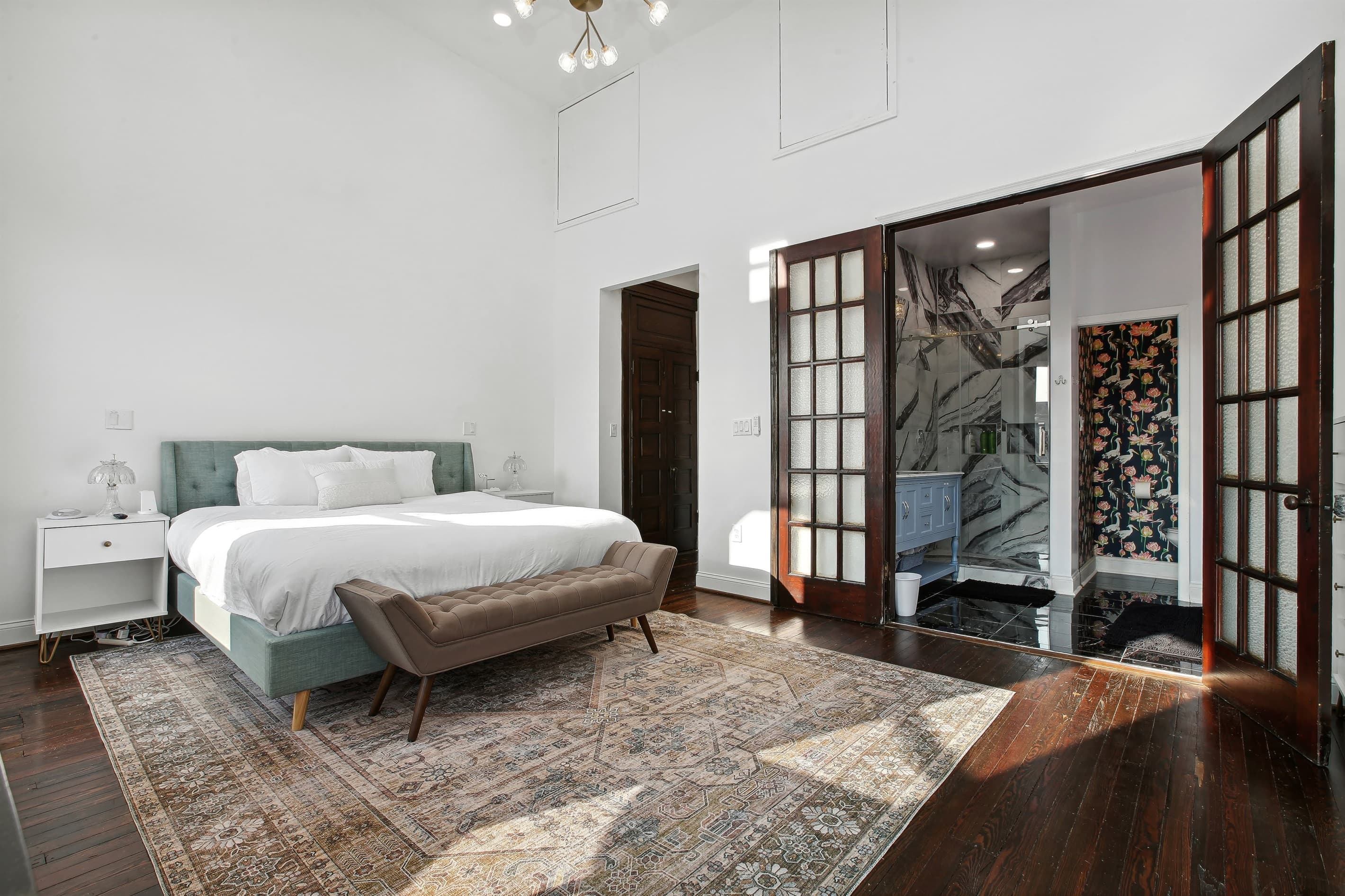 The primary bedroom has an en-suite bathroom with dual-showerheads and a clawfoot tub