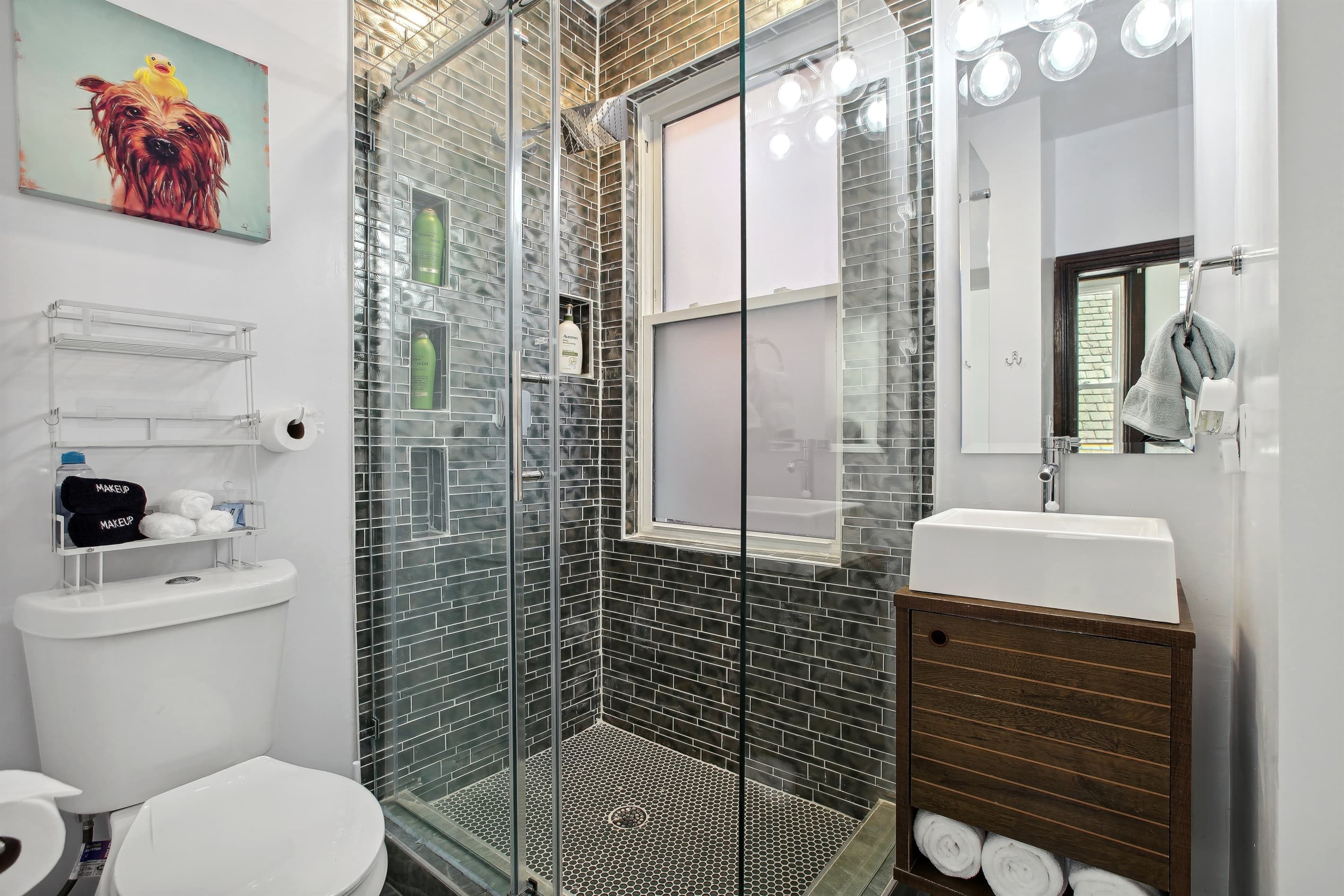 This upstairs bathroom in the center of the house has a walk-in shower with a sliding glass door