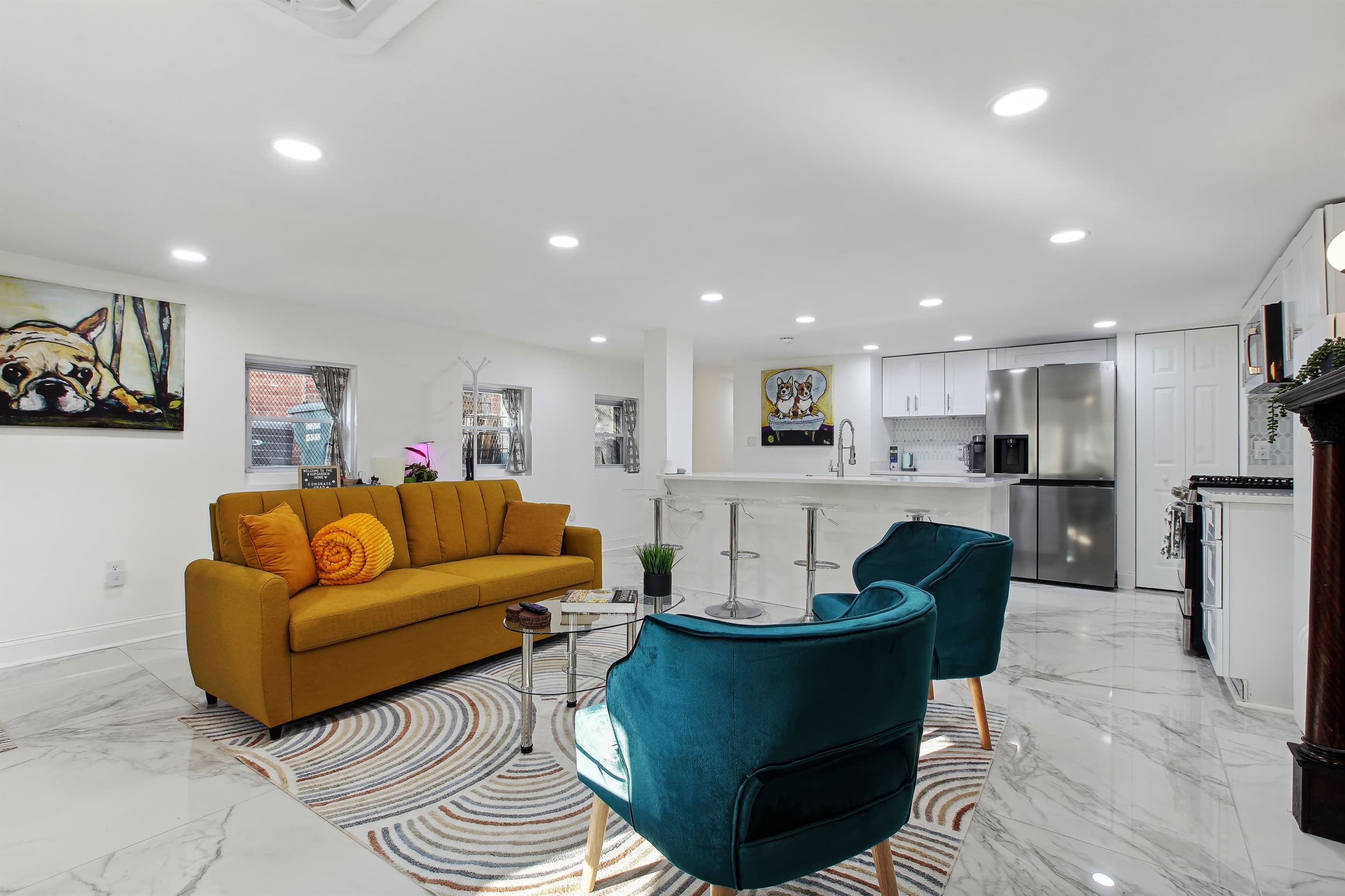 The living room can comfortably sit five people and there are additionally four stools on the kitchen island as well