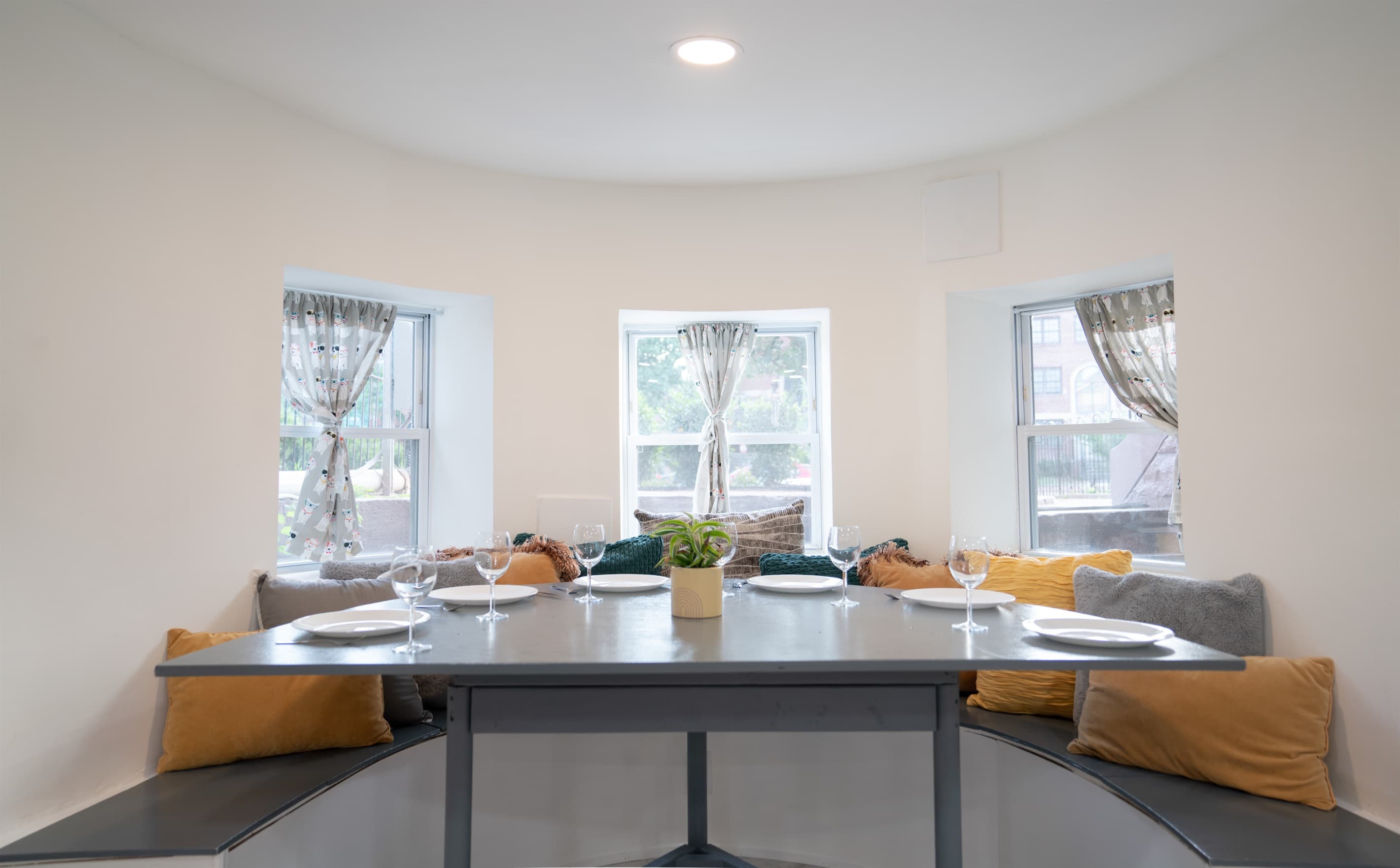 The dining nook is just off the living room and can fit up to 6 people. The stools from the kitchen island can also be used at the dining nook to seat everyone at once.