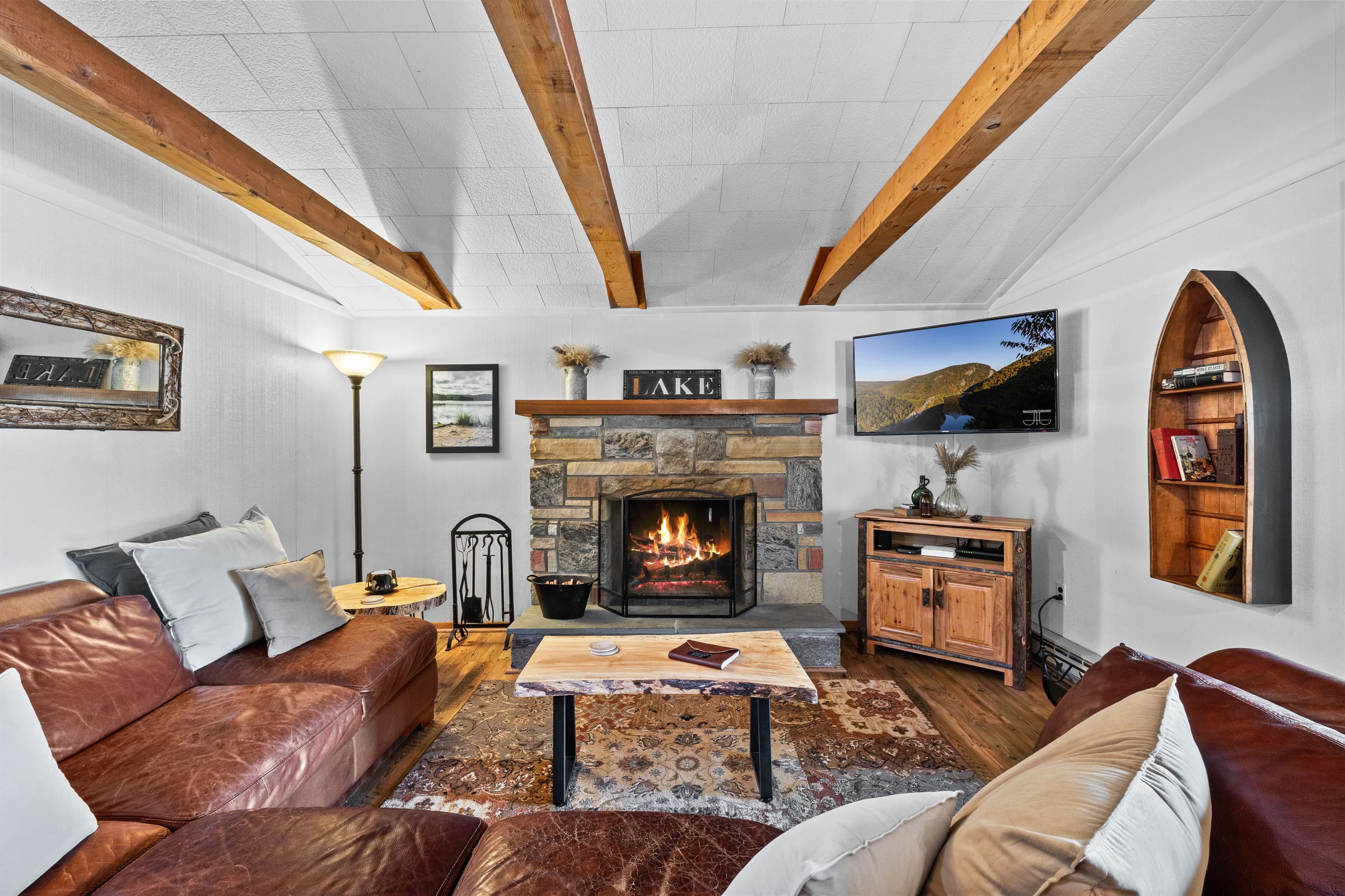 Living room with wood burning fireplace, Smart TV and seating