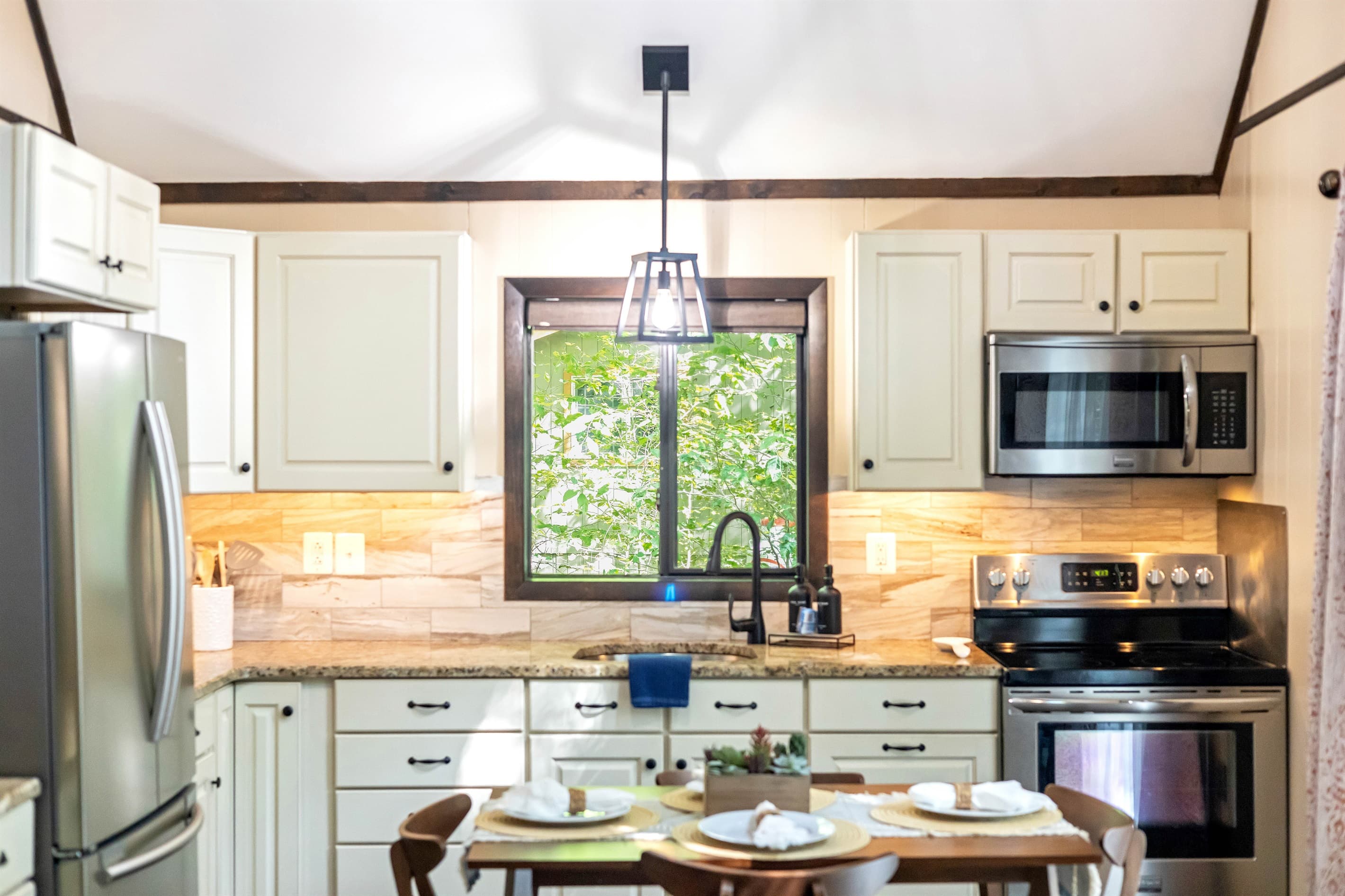 Modern kitchen with stainless steel appliances and granite countertops