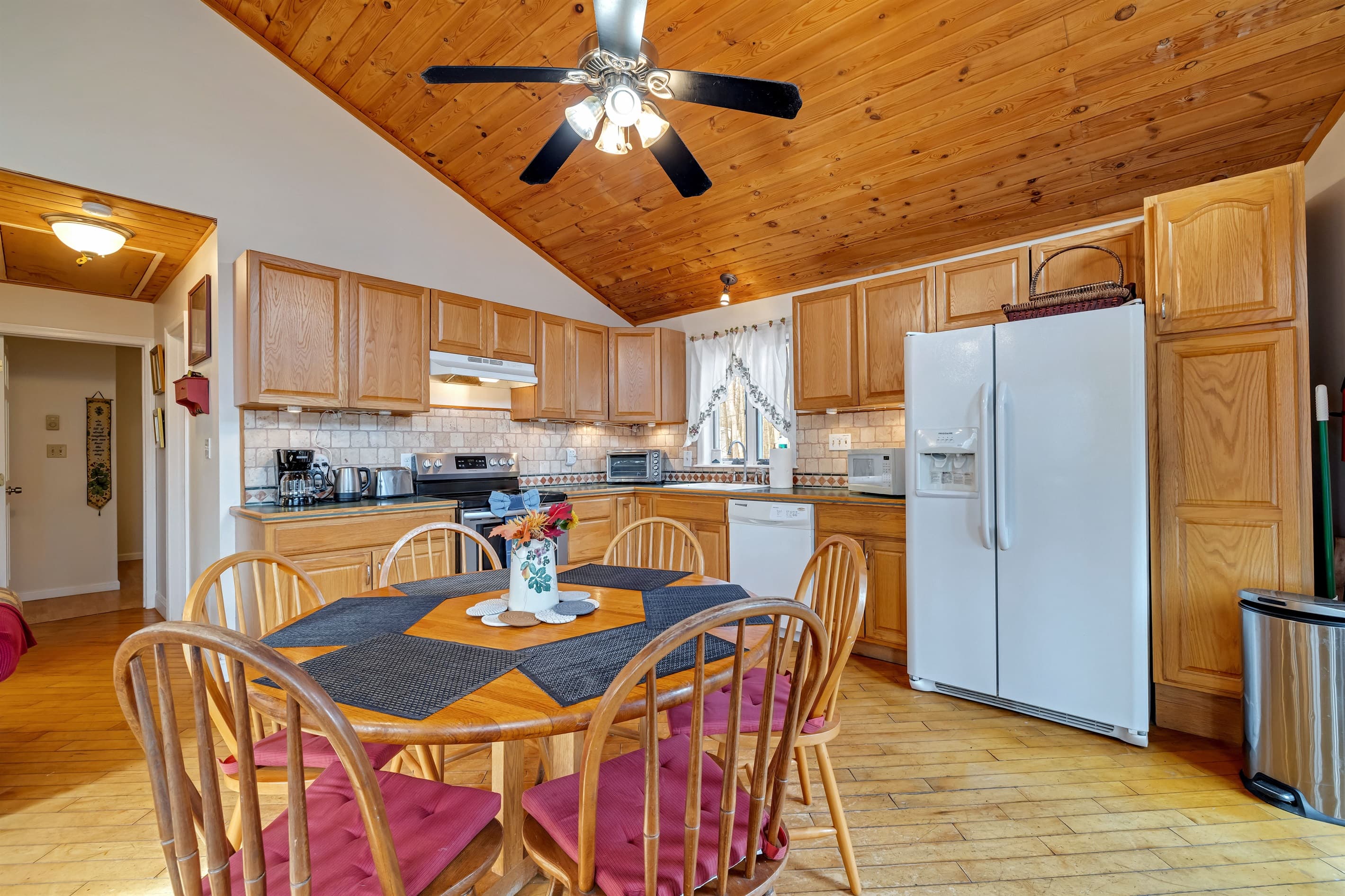 Fully stocked kitchen with large fridge, dishwasher, microwave, oven toaster, coffeemaker
