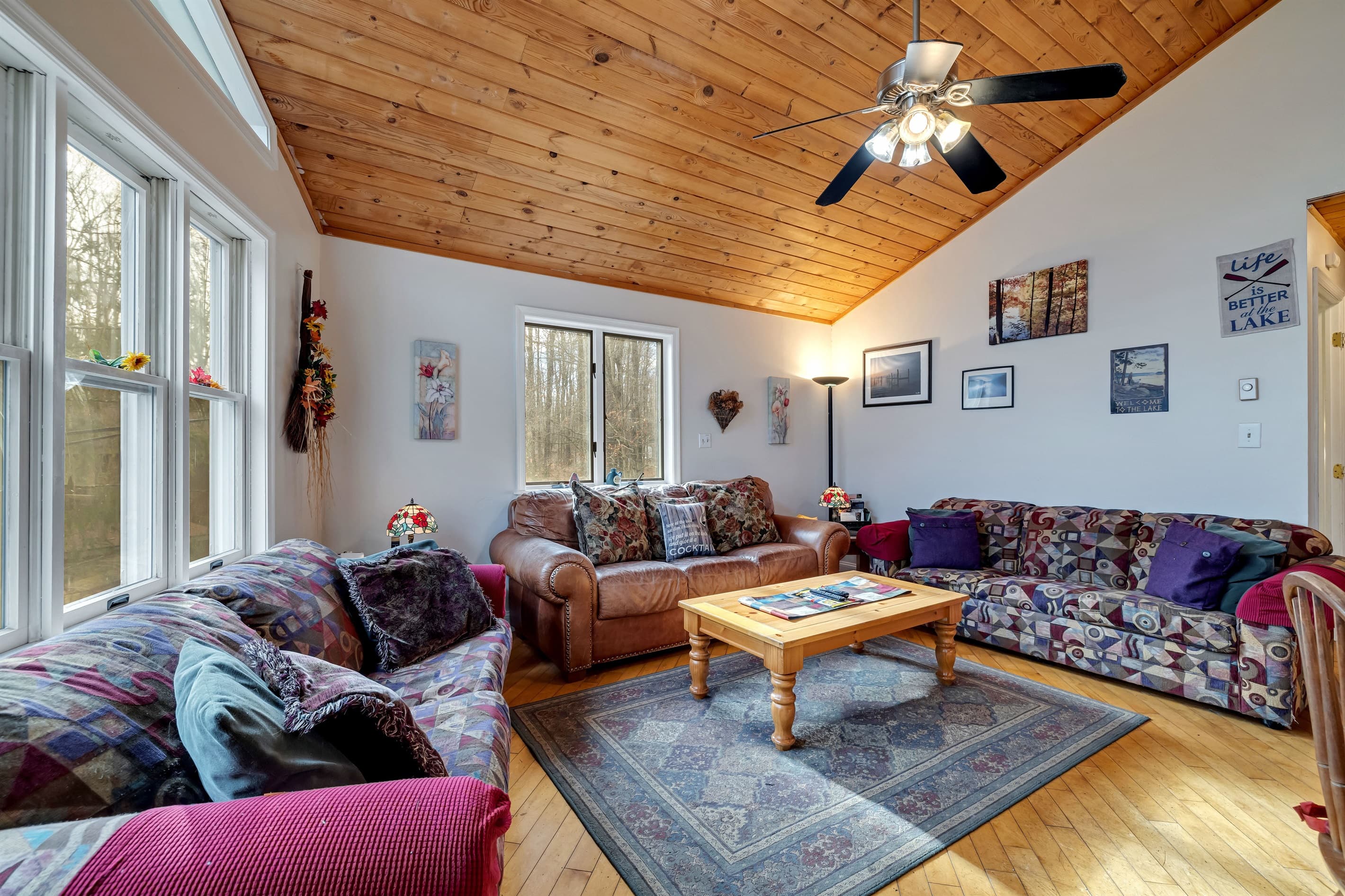 Upper-level living room with seating and TV