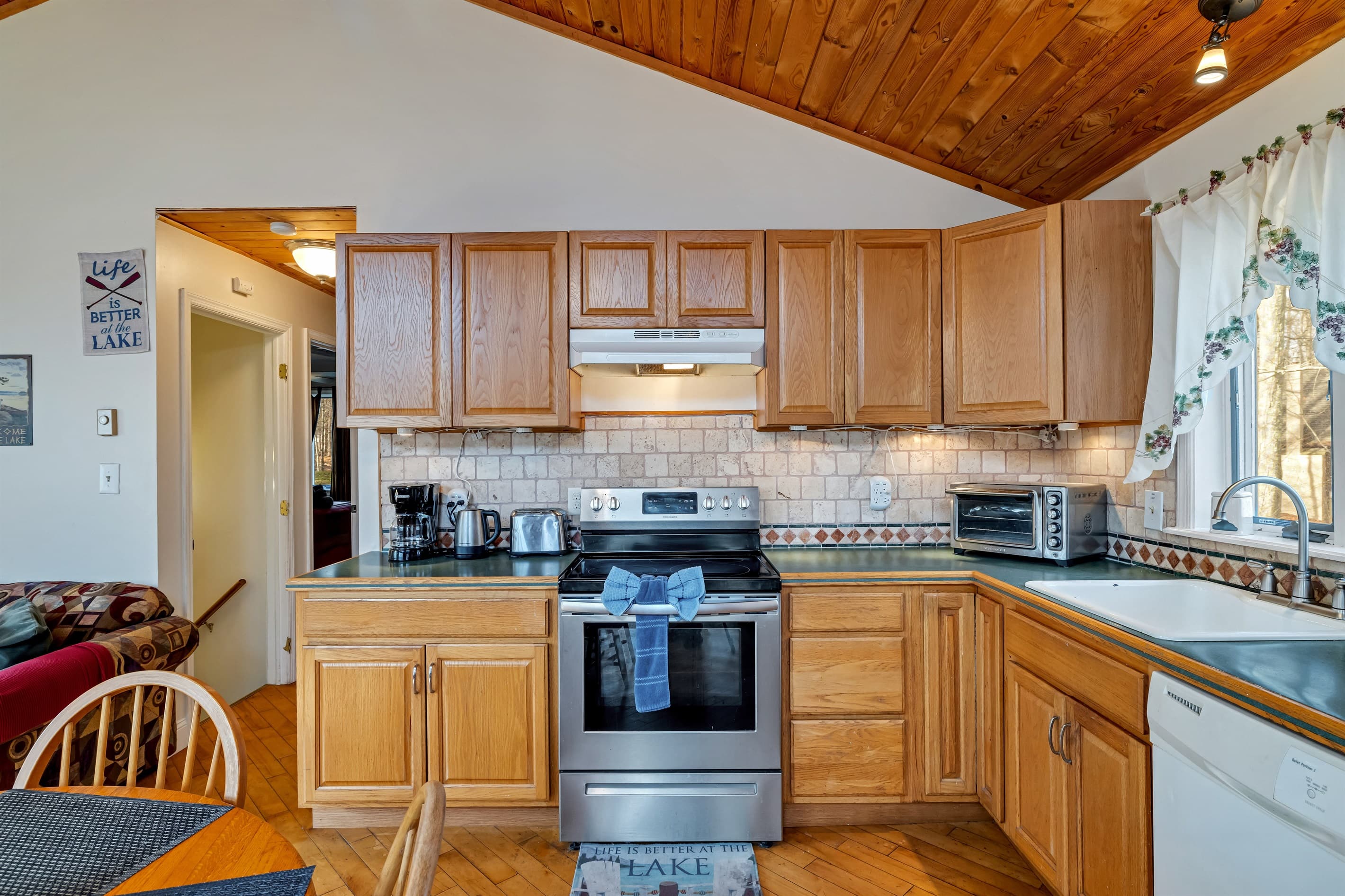 Fully stocked kitchen with large fridge, dishwasher, microwave, oven toaster, coffeemaker