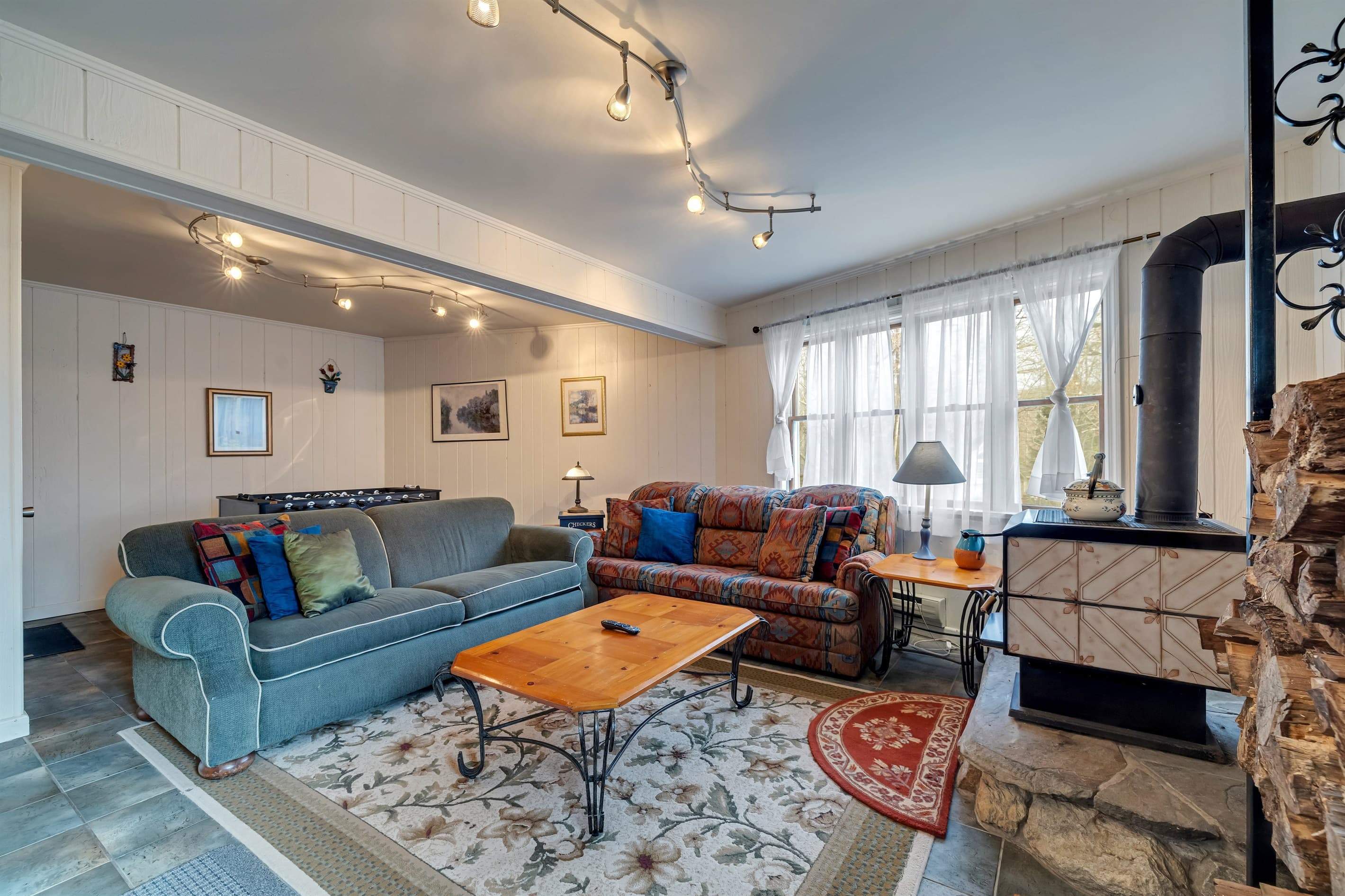 Lower-level family room with wood burning fireplace and TV
