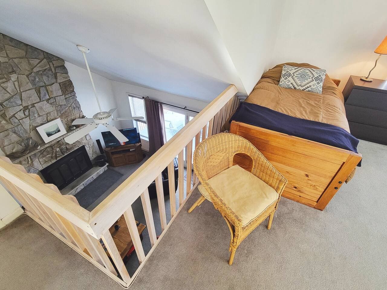 Upper level living room has two sleeping beds and tv