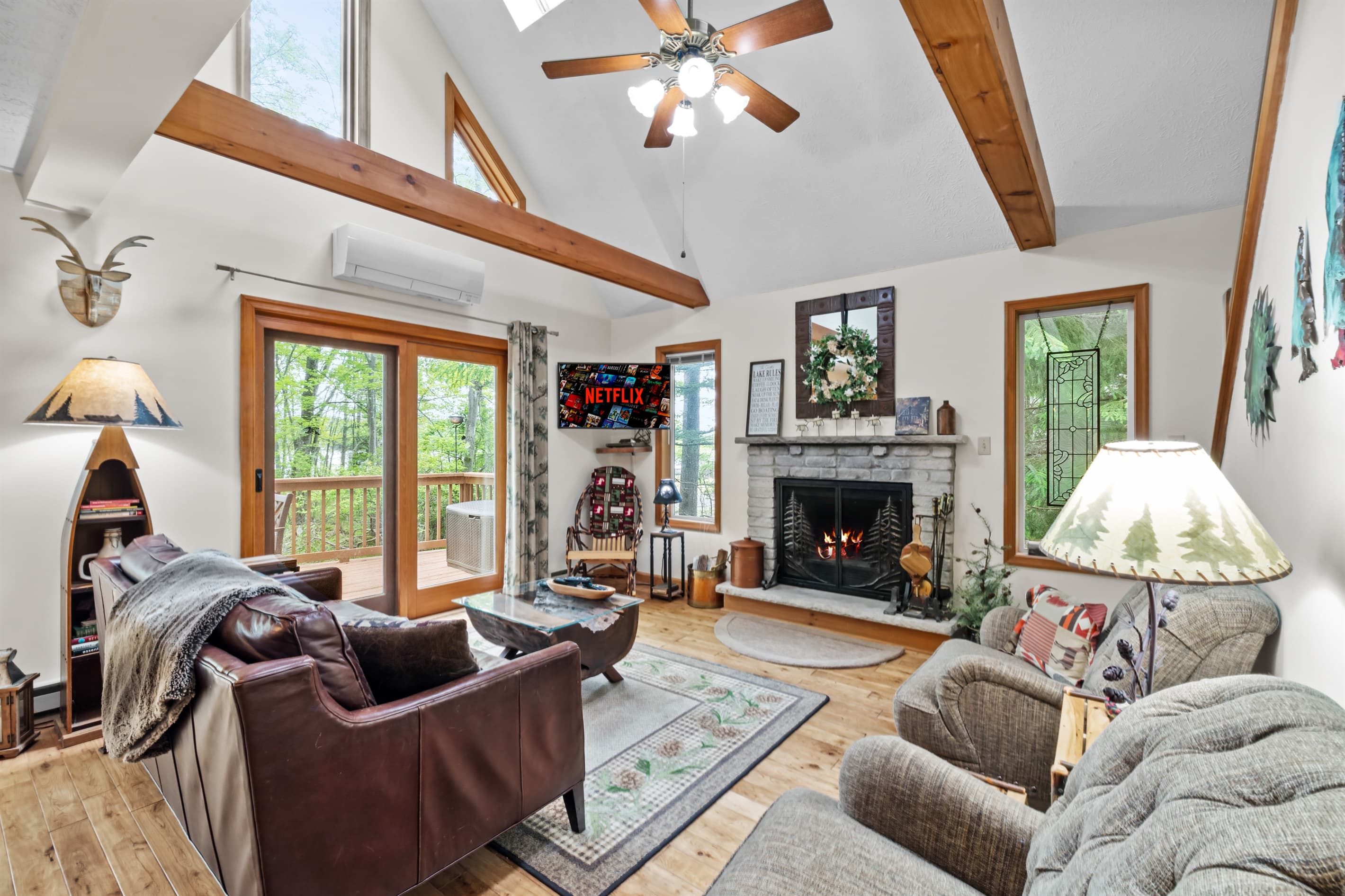 Living room with wood burning fireplace, TV and comfortable seating