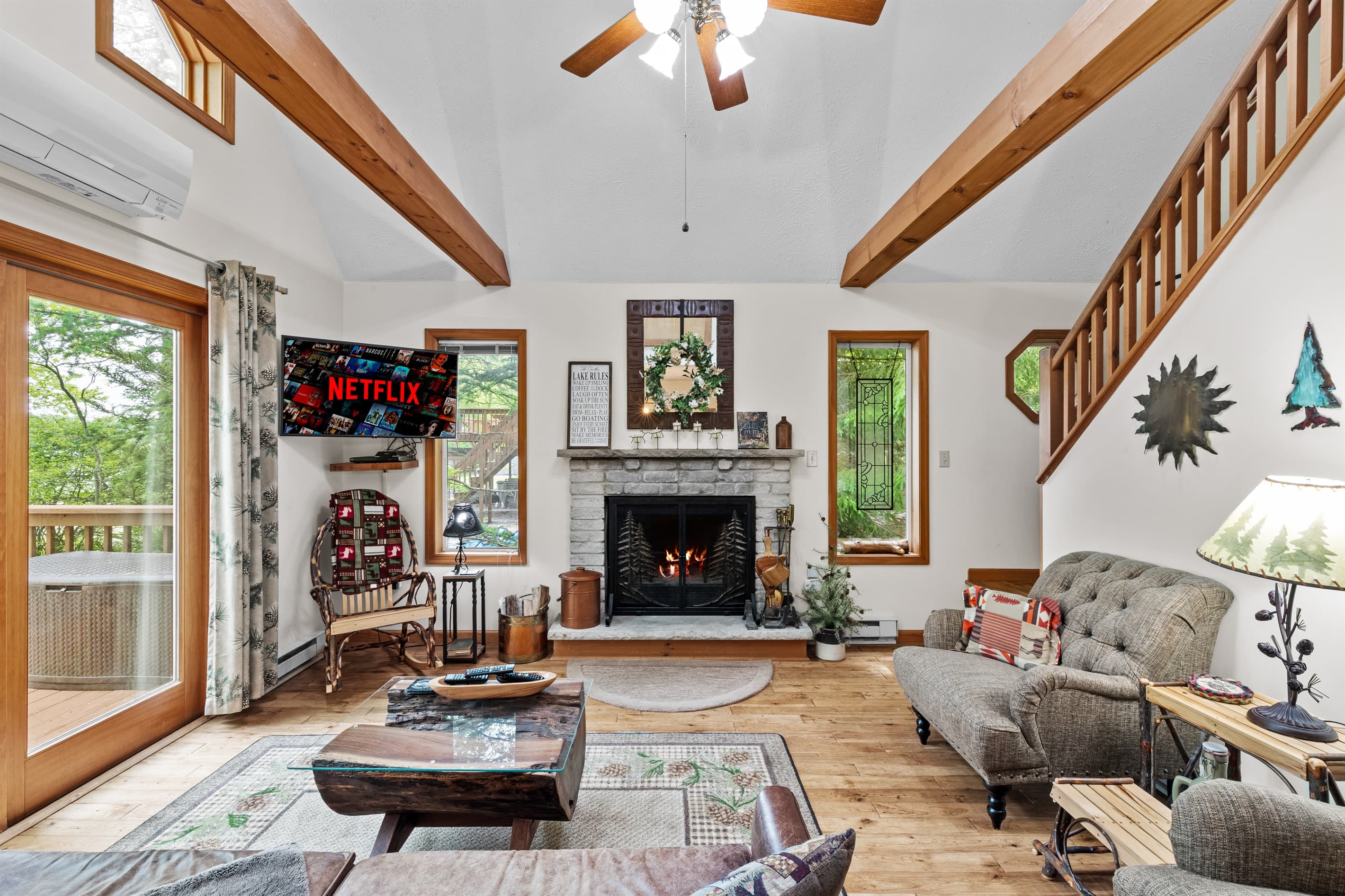 Living room with wood burning fireplace, TV and comfortable seating