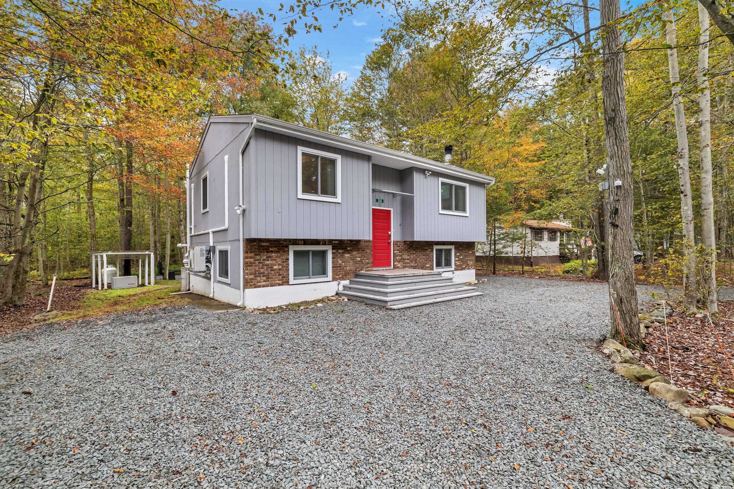 Enjoy the picturesque exterior view of the home, surrounded by nature and perfect for a peaceful getaway.