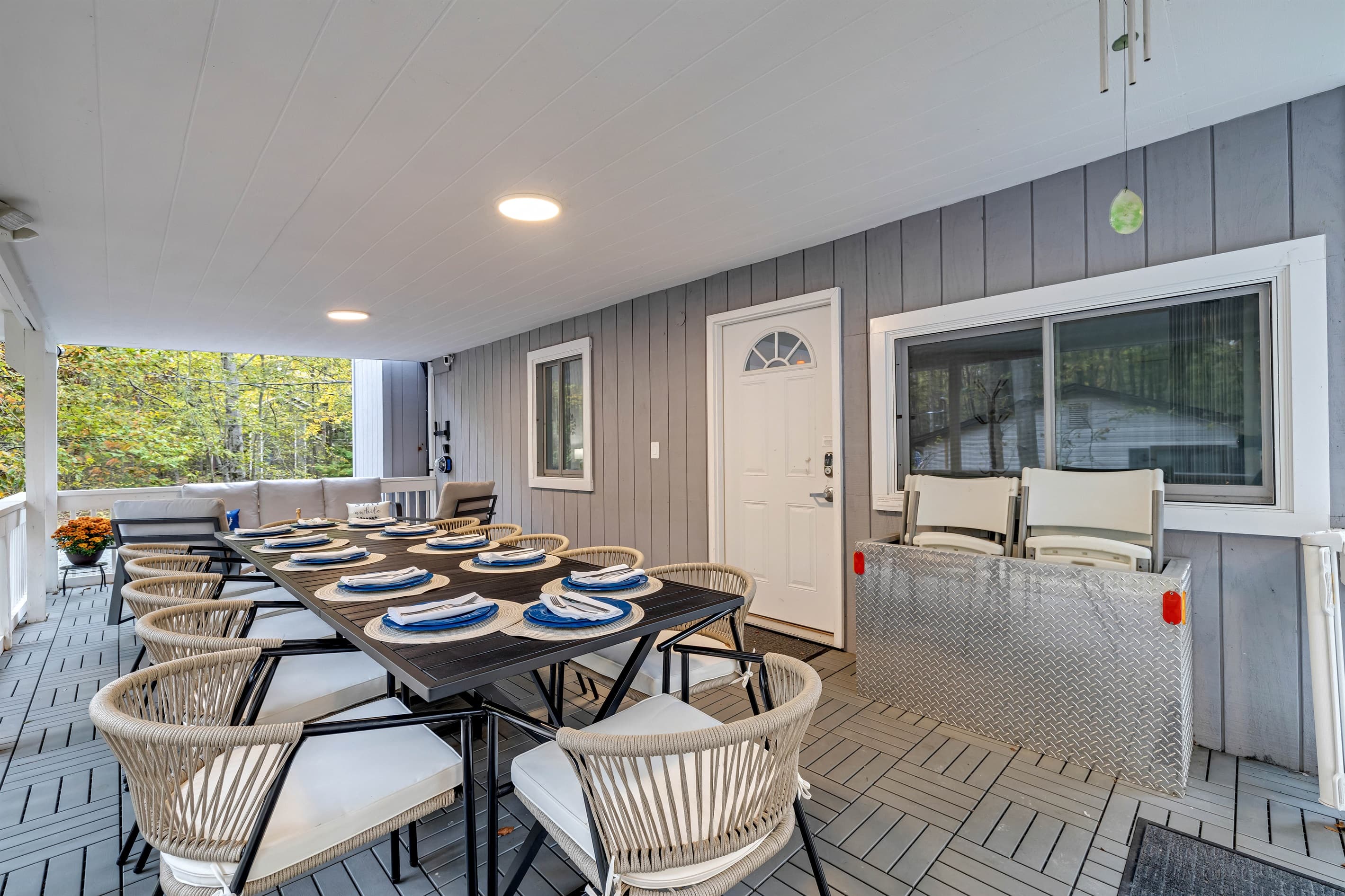 Enjoy ample seating at the outdoor table on the covered deck, perfect for meals and gatherings.
