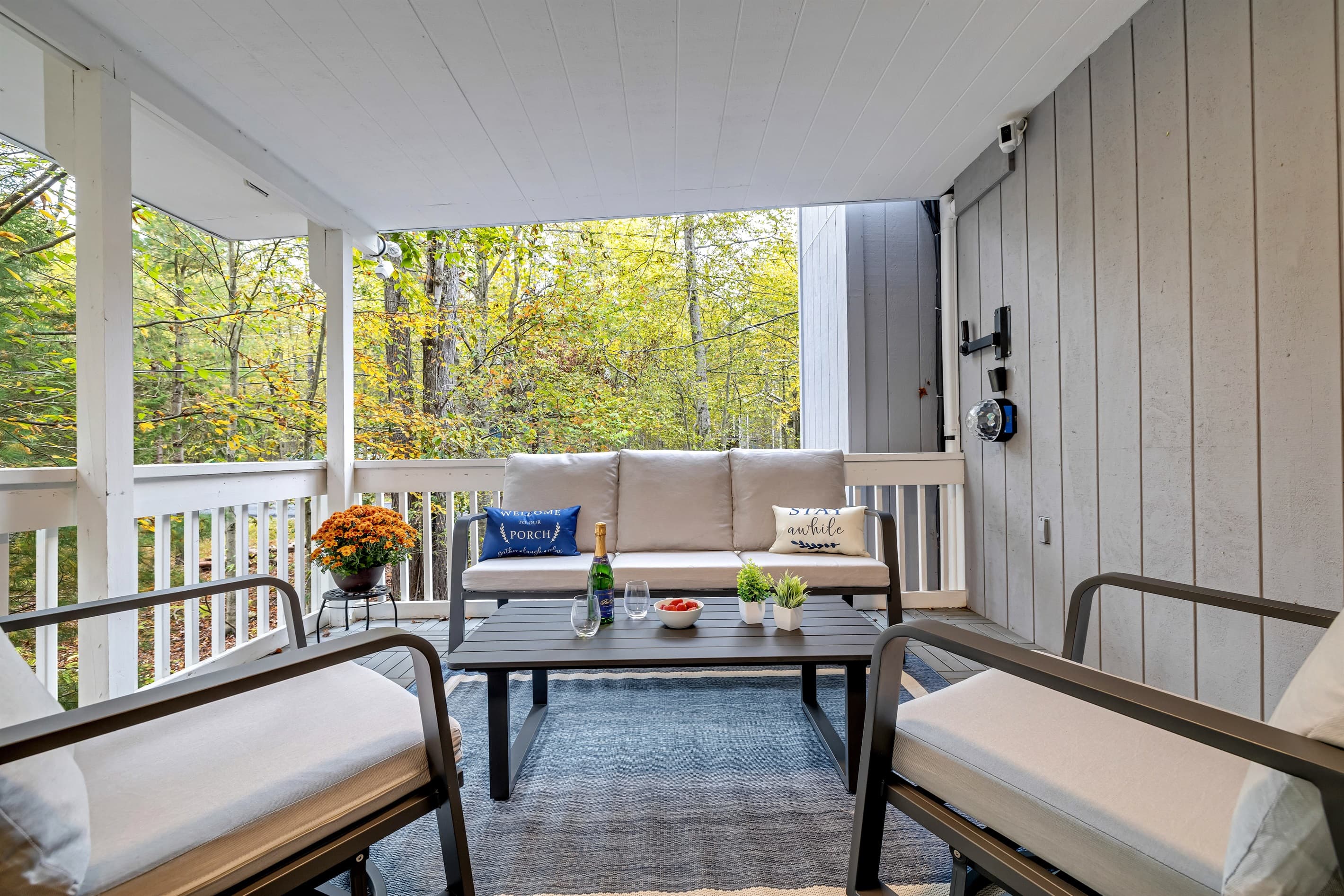 Enjoy ample seating at the outdoor table on the covered deck, perfect for meals and gatherings.
