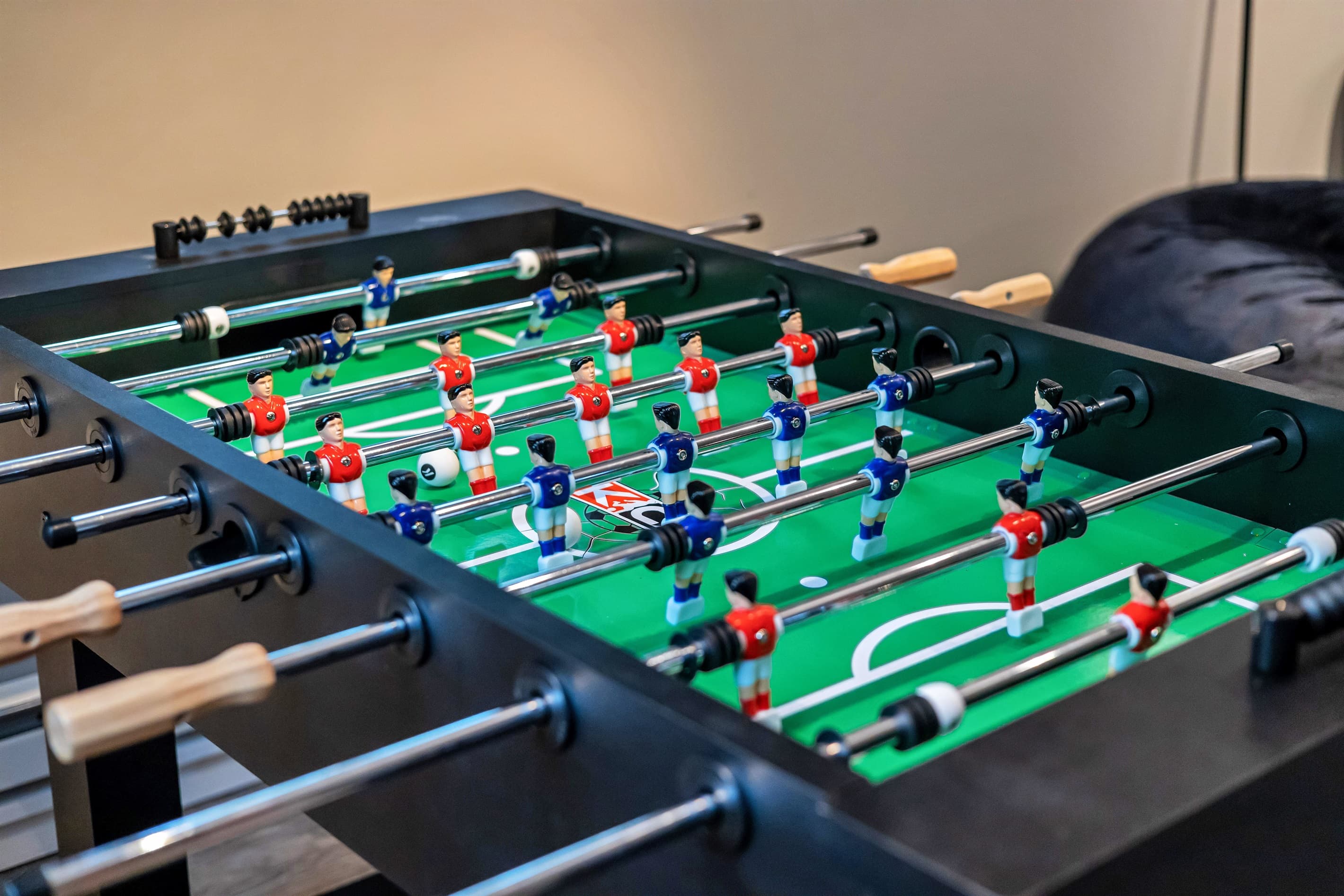 Enjoy some friendly competition in the game room with a classic foosball table, perfect for fun and relaxation.