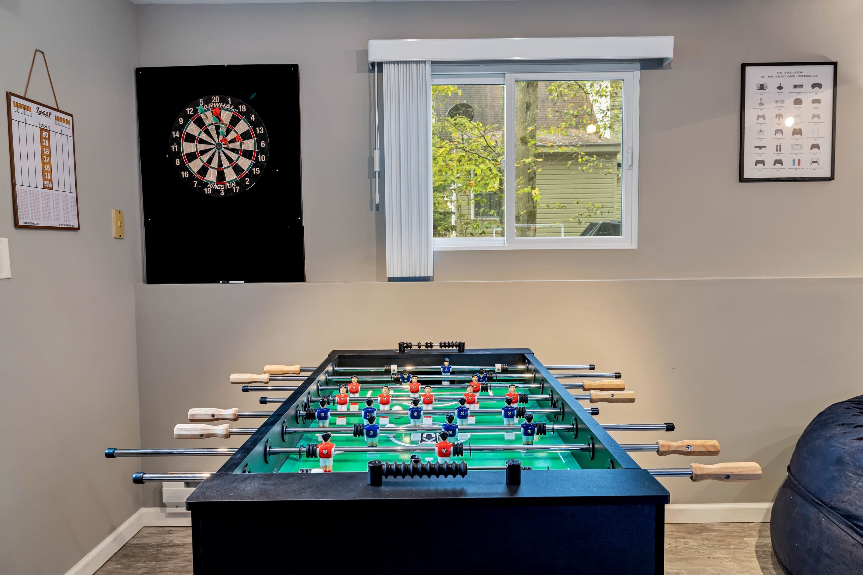 The game room is a fun-filled space with a foosball table, PS4, TV, darts, arcade games, and a variety of board games, perfect for entertainment and relaxation