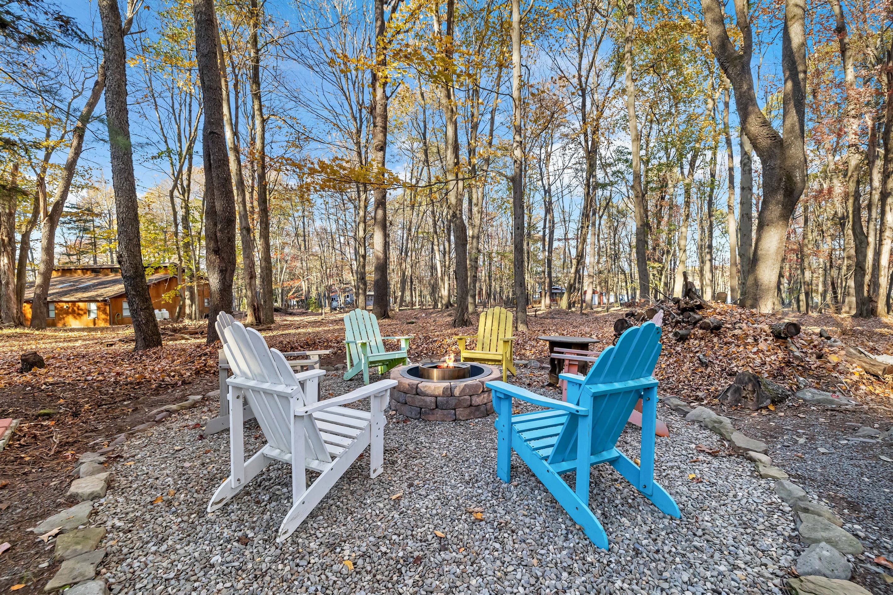 Outdoor firepit surrounded by Adirondack-style chairs, perfect for cozy evenings by the fire, sharing stories, and enjoying the fresh mountain air with friends and family