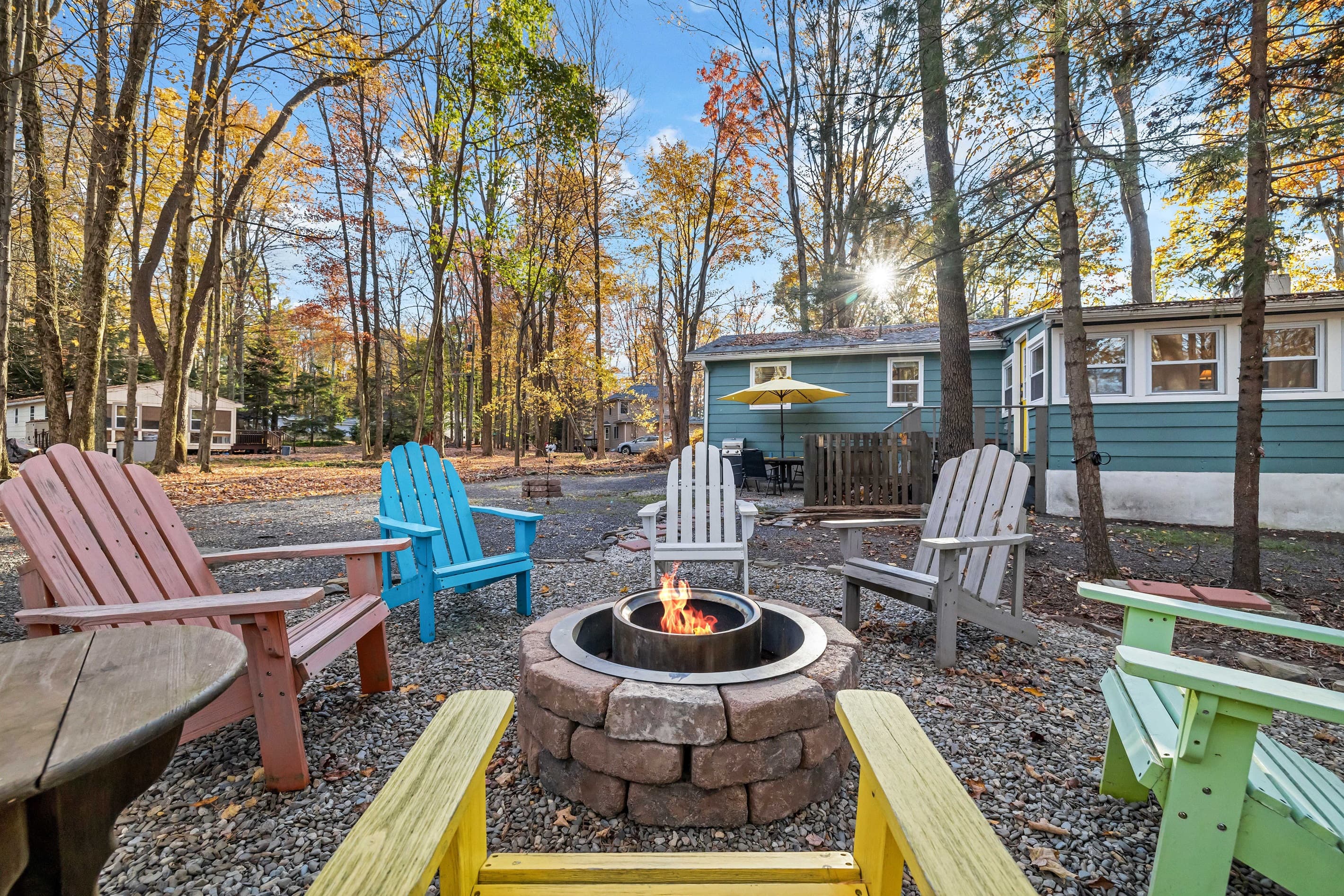 Outdoor firepit surrounded by Adirondack-style chairs, perfect for cozy evenings by the fire, sharing stories, and enjoying the fresh mountain air with friends and family