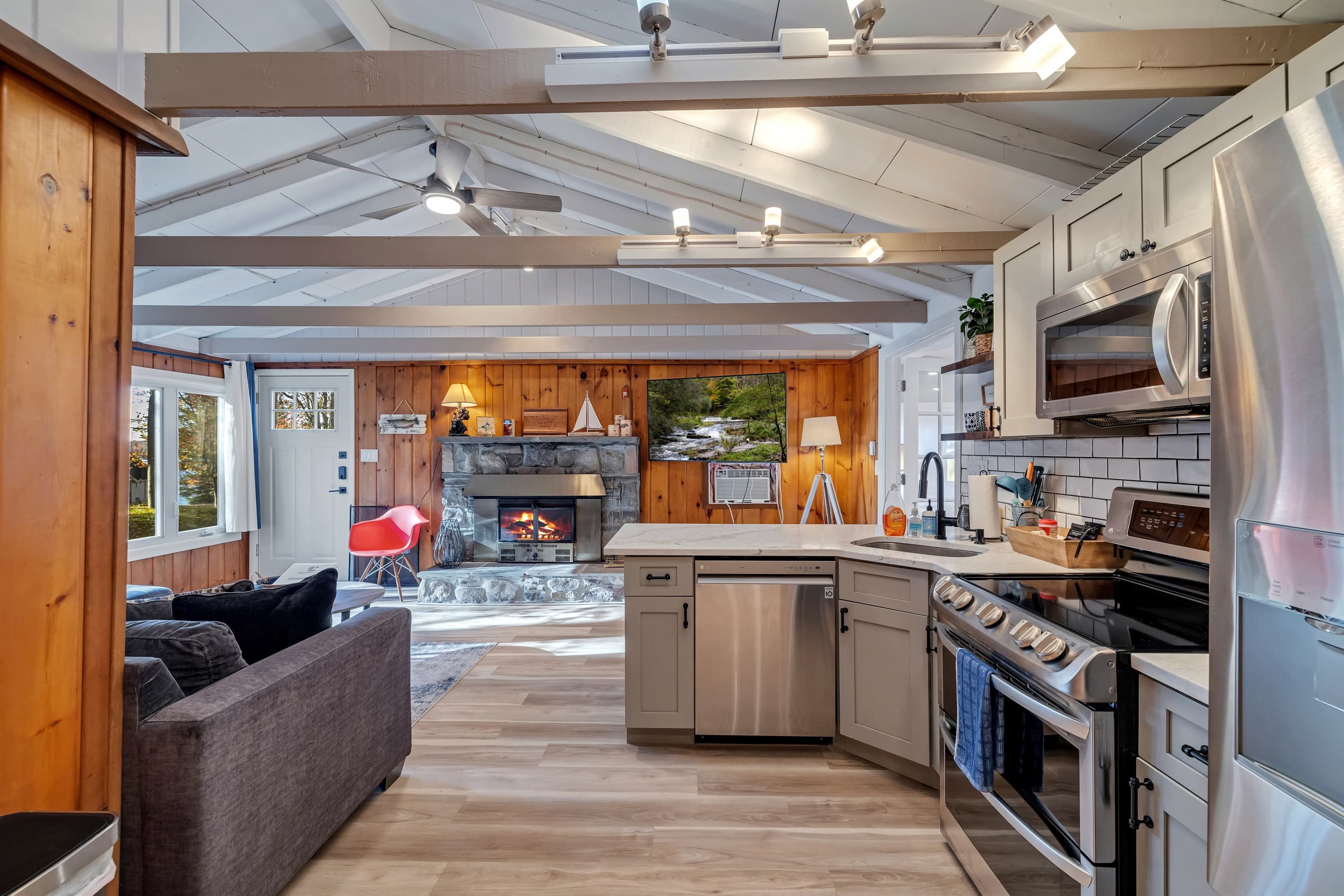 Modern kitchen with sleek quartz countertops, stainless steel appliances, and a breakfast counter, offering a stylish and functional space for cooking and dining | Serhii Vacation Rentals