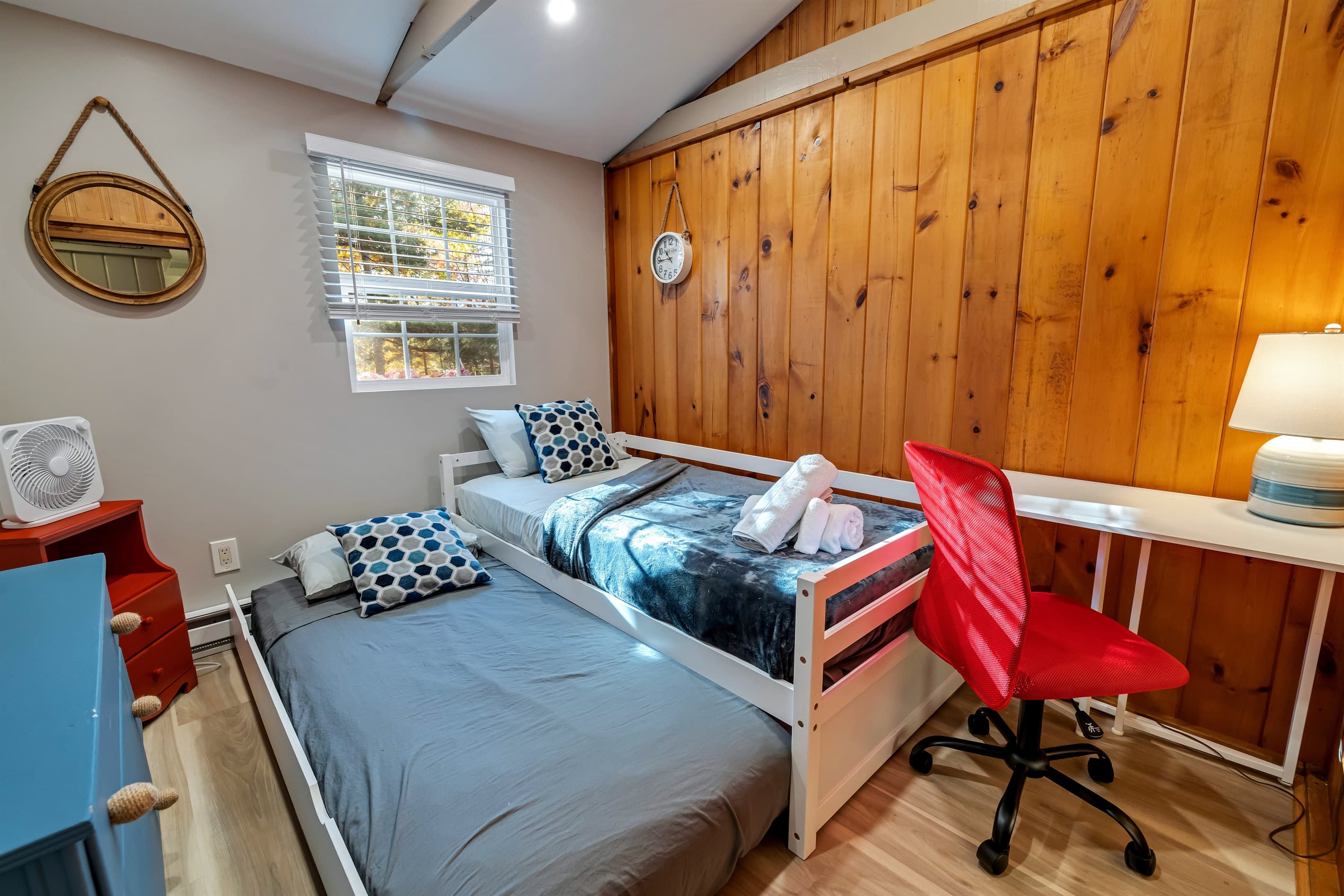 Cozy bedroom with a comfortable trundle bed and a small workspace for your laptop. Perfect for relaxation and catching up on work during your stay.