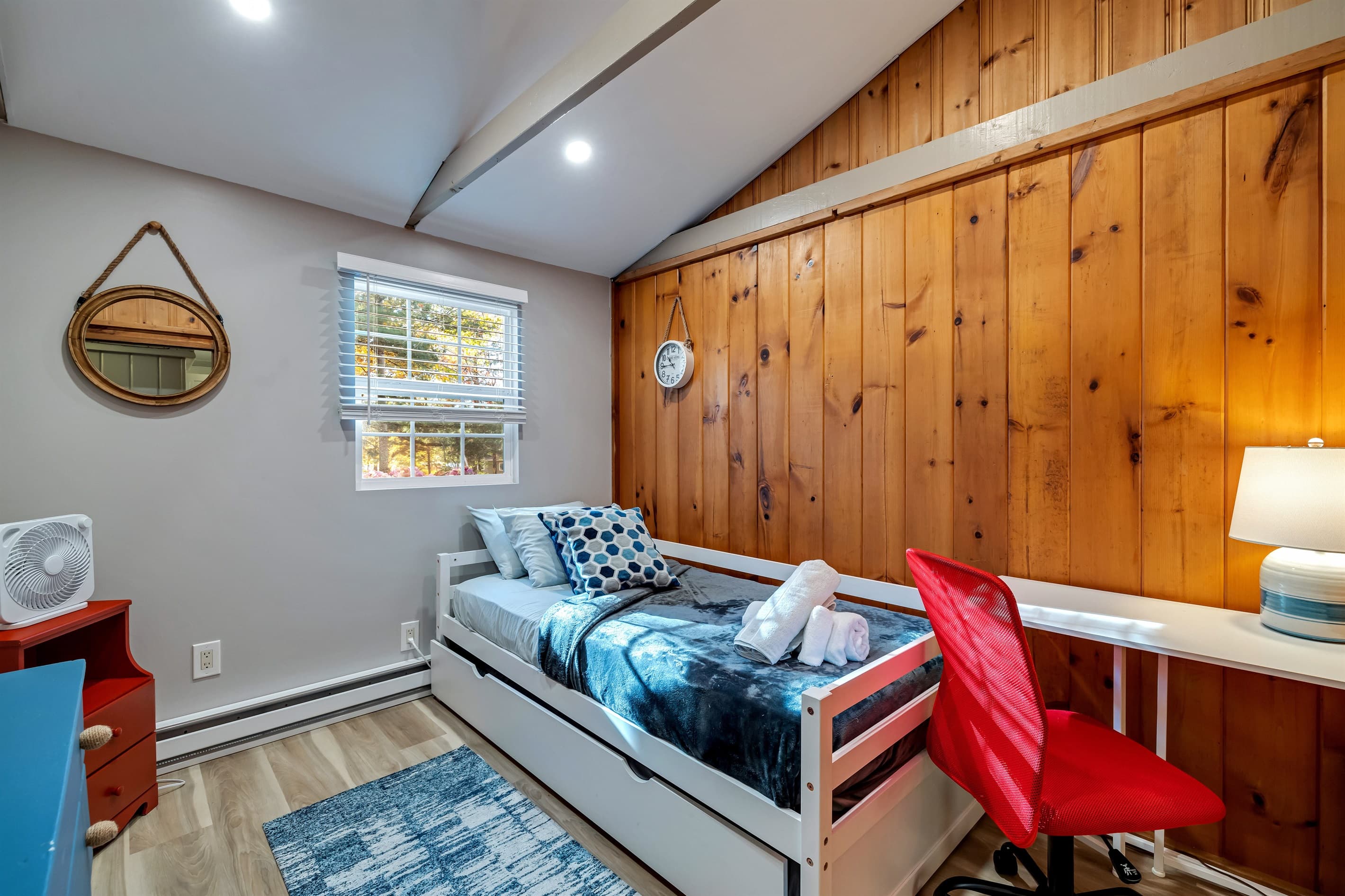 Cozy bedroom with a comfortable trundle bed and a small workspace for your laptop. Perfect for relaxation and catching up on work during your stay.