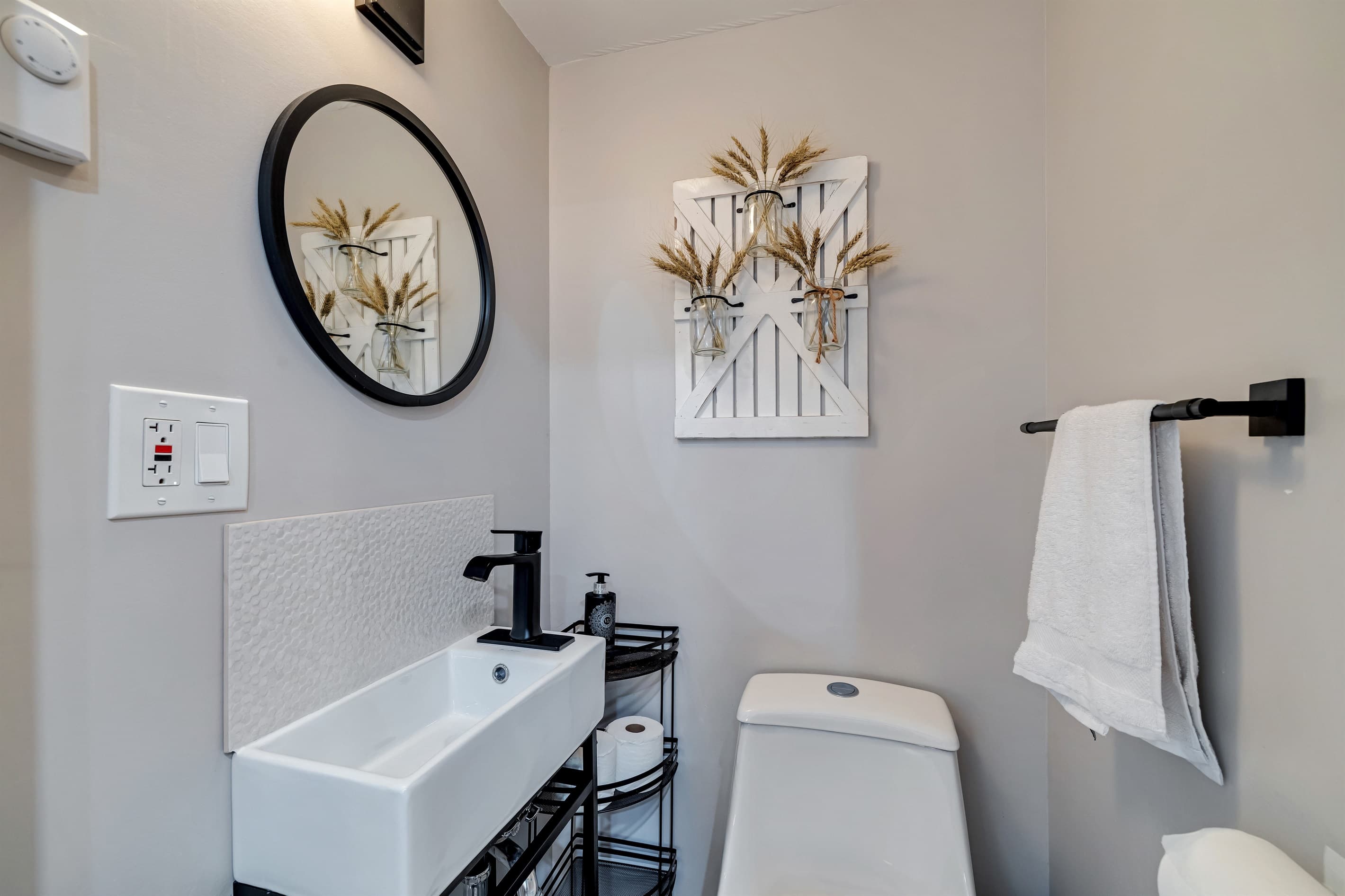 Bathroom with a toilet and sink, providing convenience and privacy during your stay. A practical space for your daily needs!