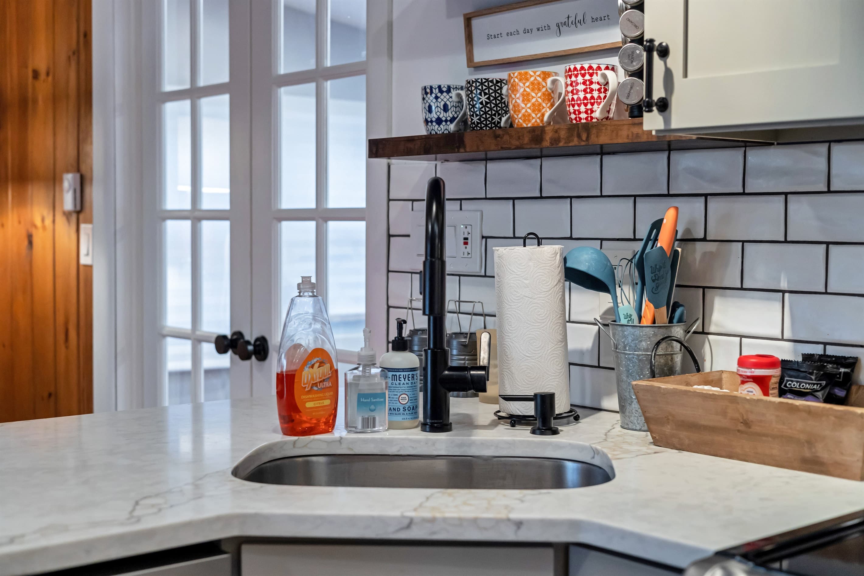 Modern kitchen with sleek quartz countertops, stainless steel appliances, and a breakfast counter, offering a stylish and functional space for cooking and dining | Serhii Vacation Rentals