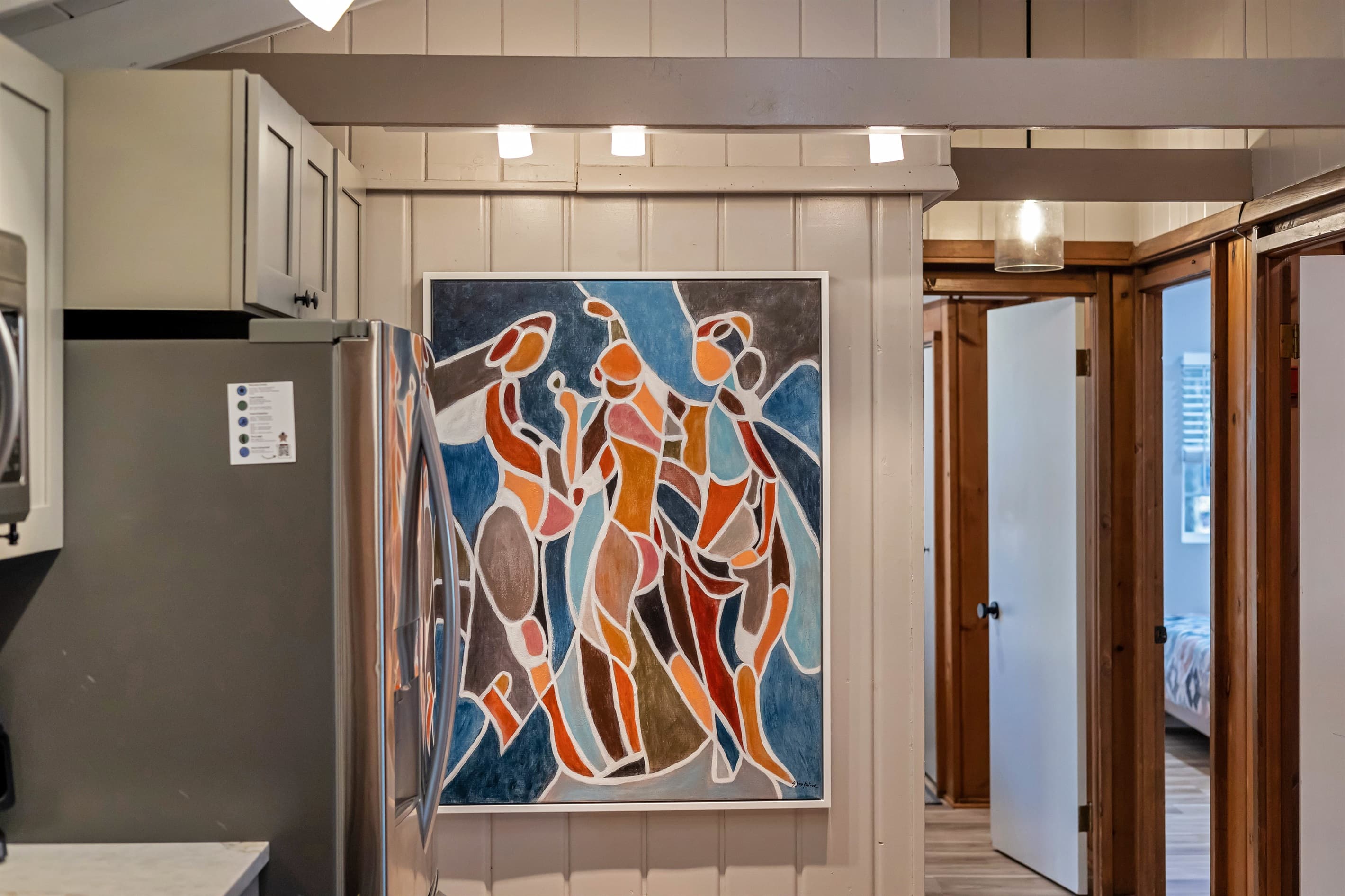 Modern kitchen with sleek quartz countertops, stainless steel appliances, and a breakfast counter, offering a stylish and functional space for cooking and dining | Serhii Vacation Rentals