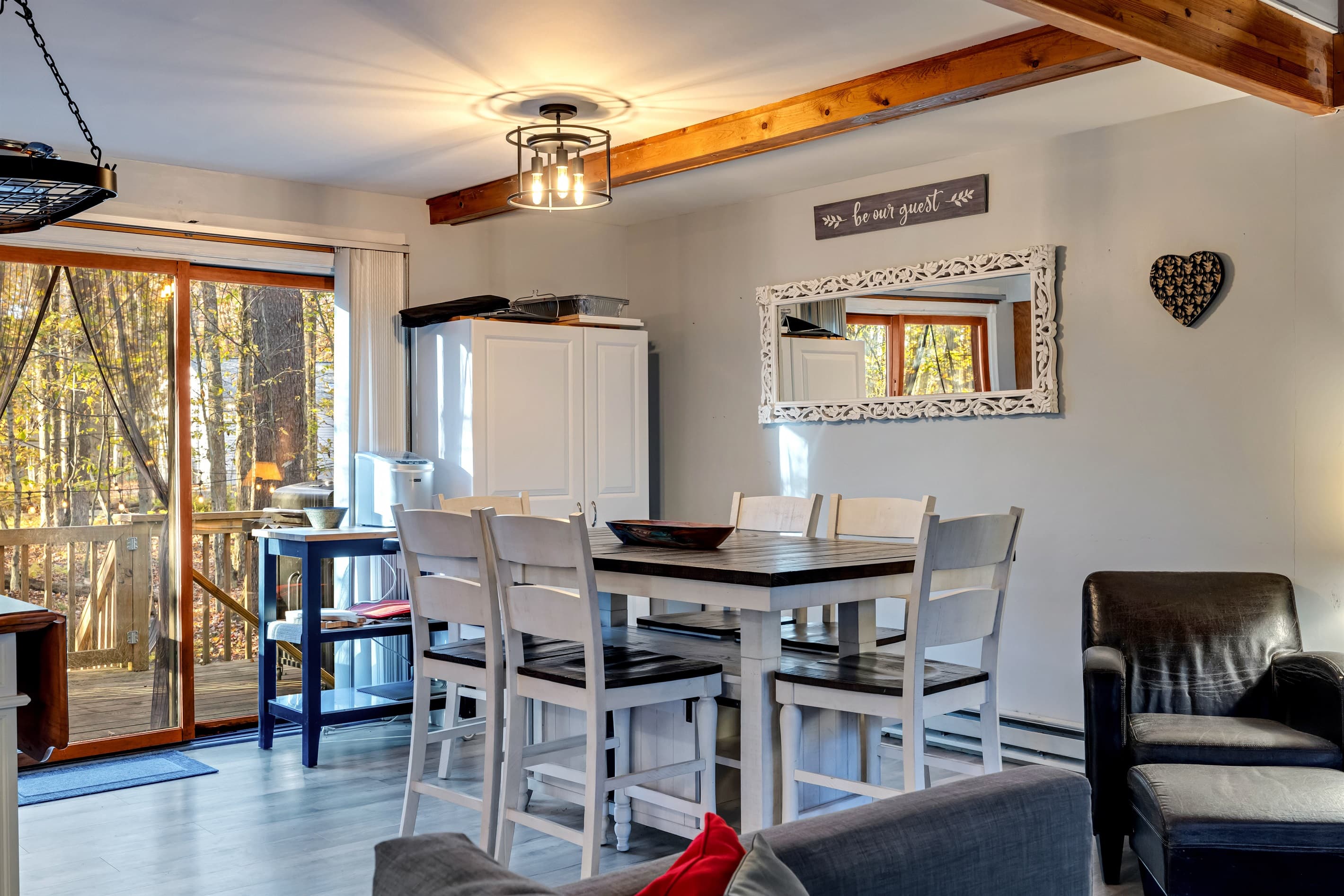 Dining area featuring a raised table and chairs, providing a stylish and comfortable space for meals and gatherings