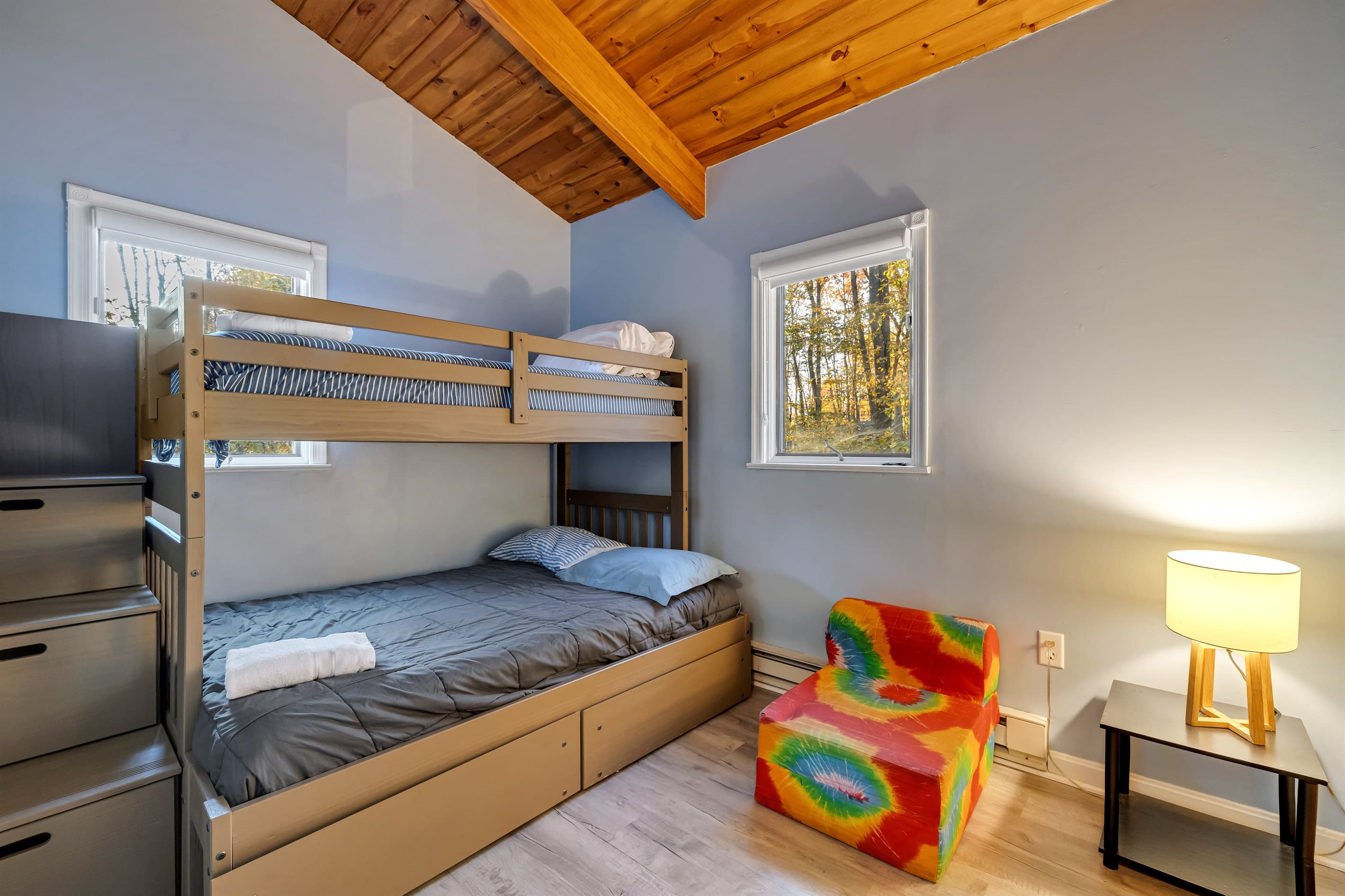 Bedroom with a twin-over-full bunk bed, perfect for kids or adults seeking a fun and cozy sleeping arrangement after a day of adventure.
