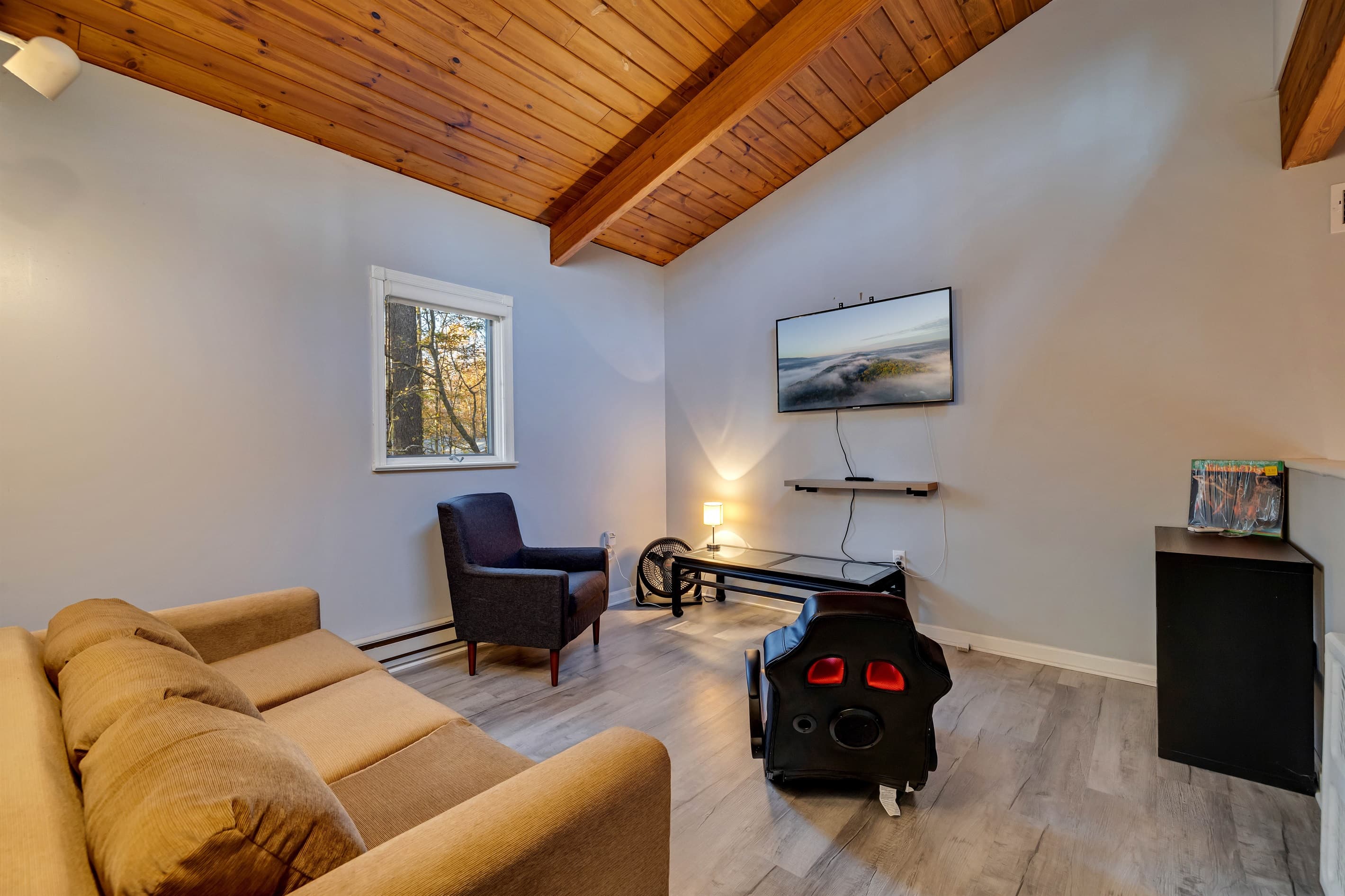 Comfortable loft area with a cozy sofa and TV, offering a relaxed space for lounging or watching your favorite shows