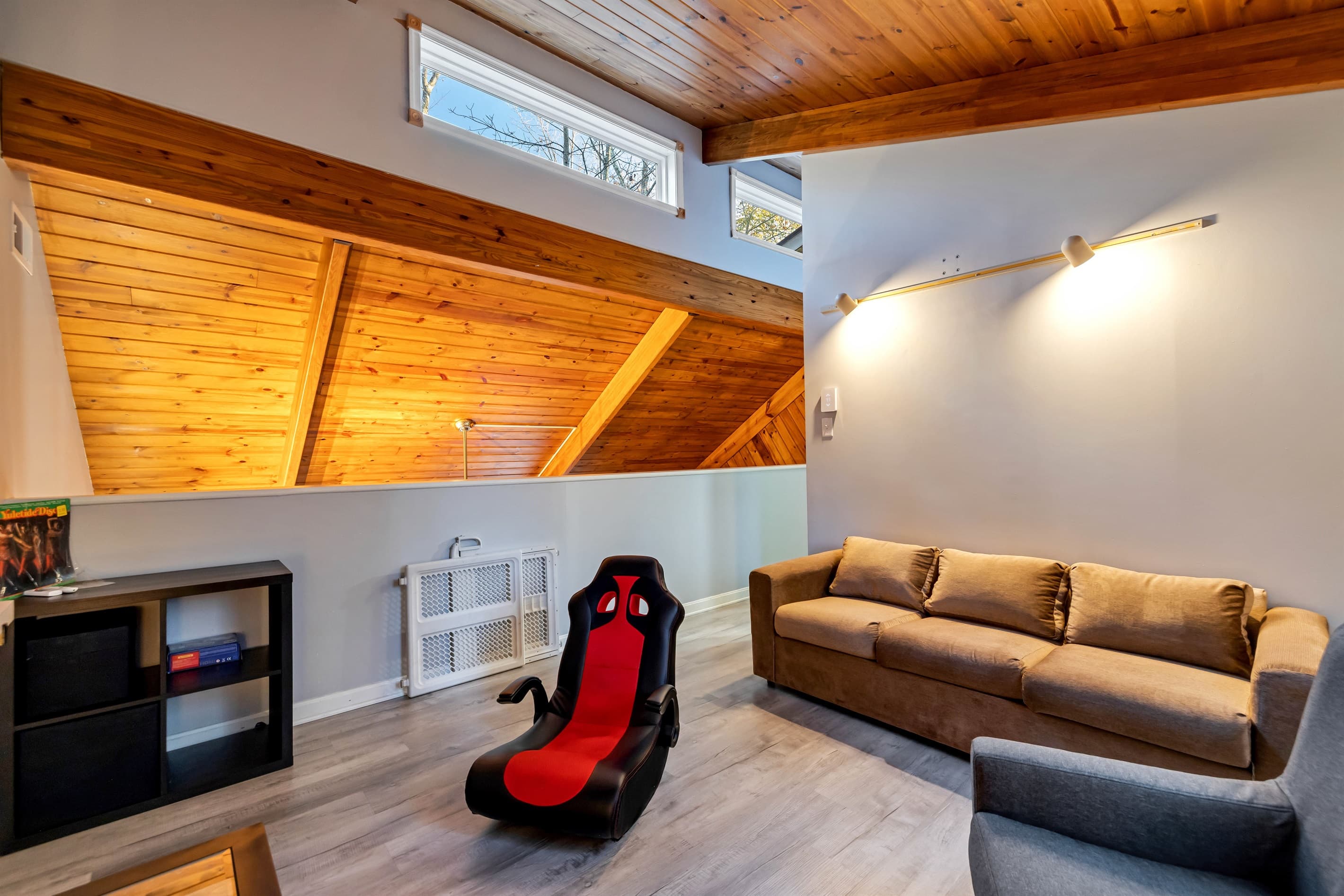 Comfortable loft area with a cozy sofa and TV, offering a relaxed space for lounging or watching your favorite shows