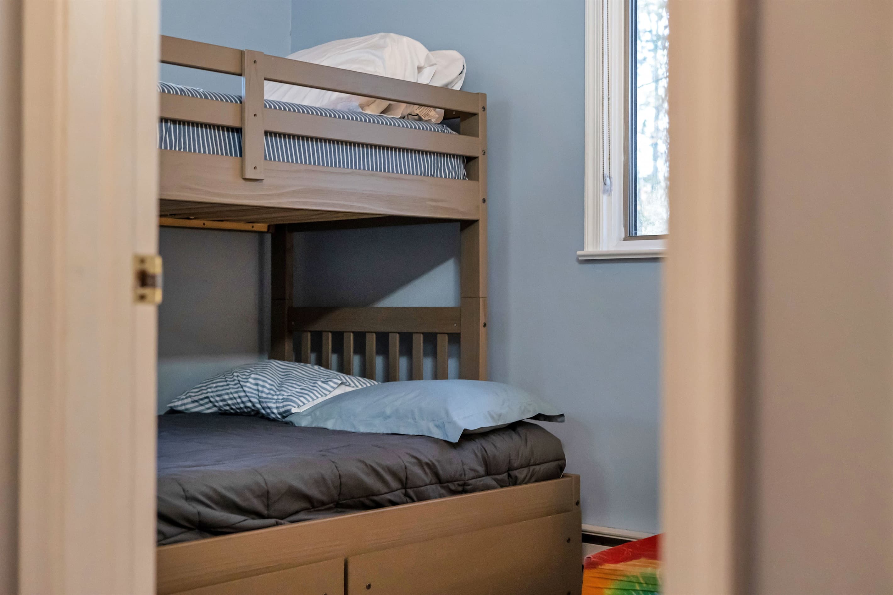 Bedroom with a twin-over-full bunk bed, perfect for kids or adults seeking a fun and cozy sleeping arrangement after a day of adventure.