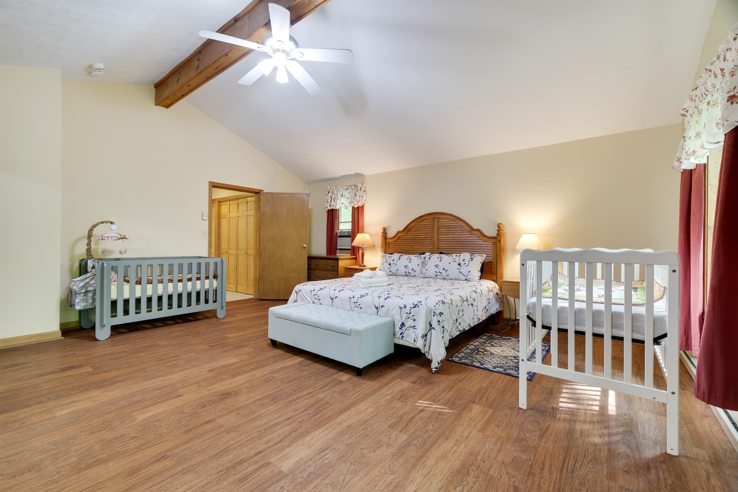Master bedroom with king size bed and 2 cribs