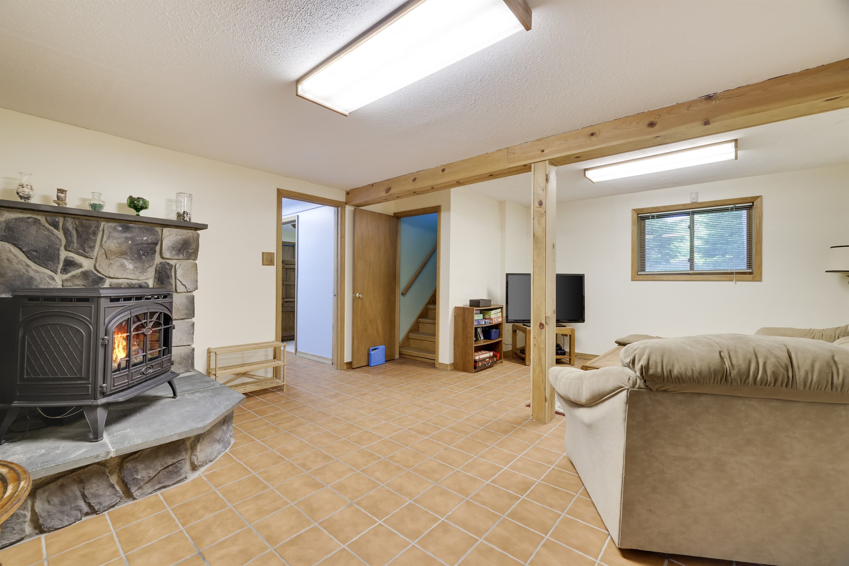 Lower level family area with fireplace and TV