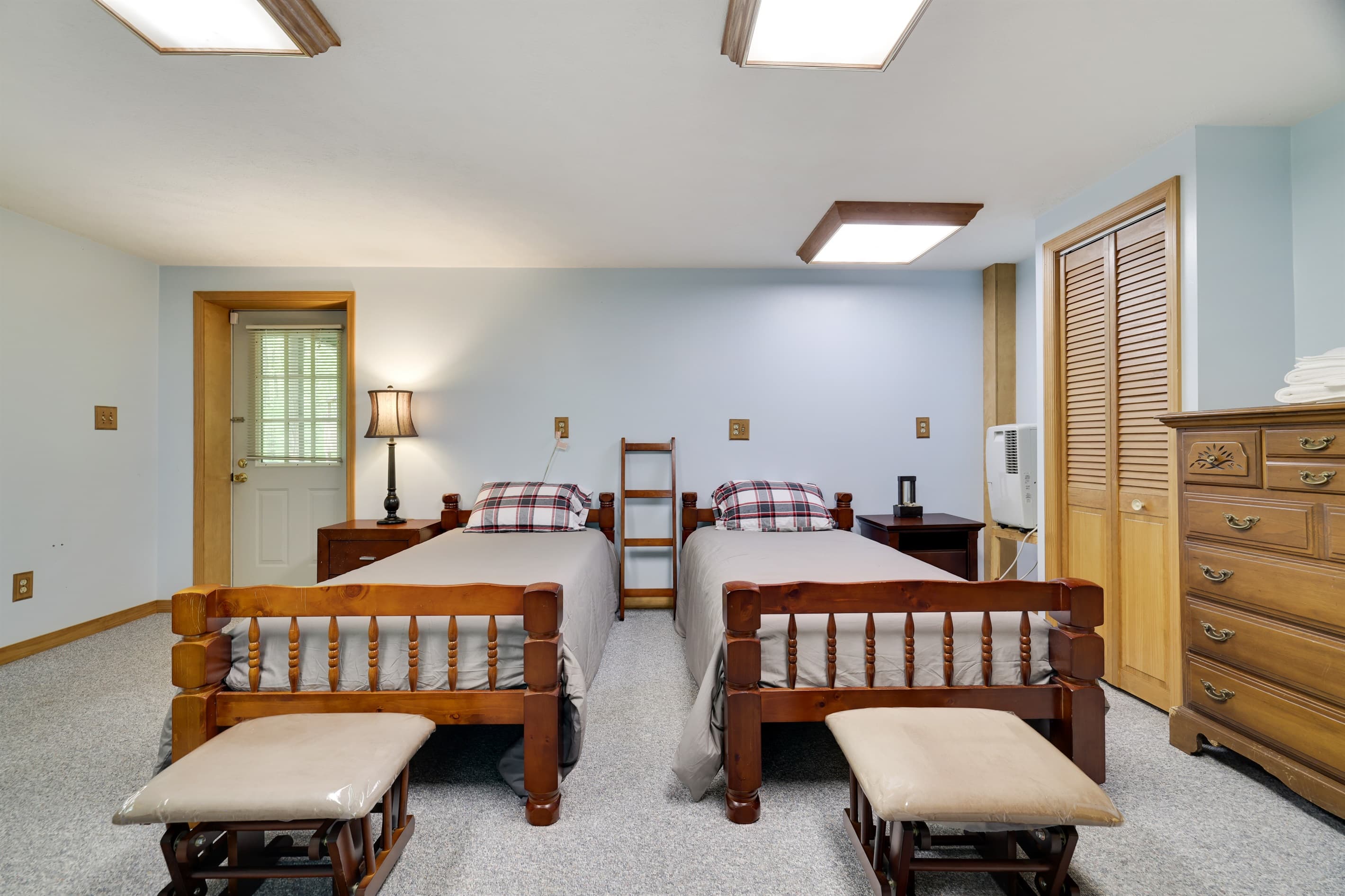 bedroom with two twin beds and a crib