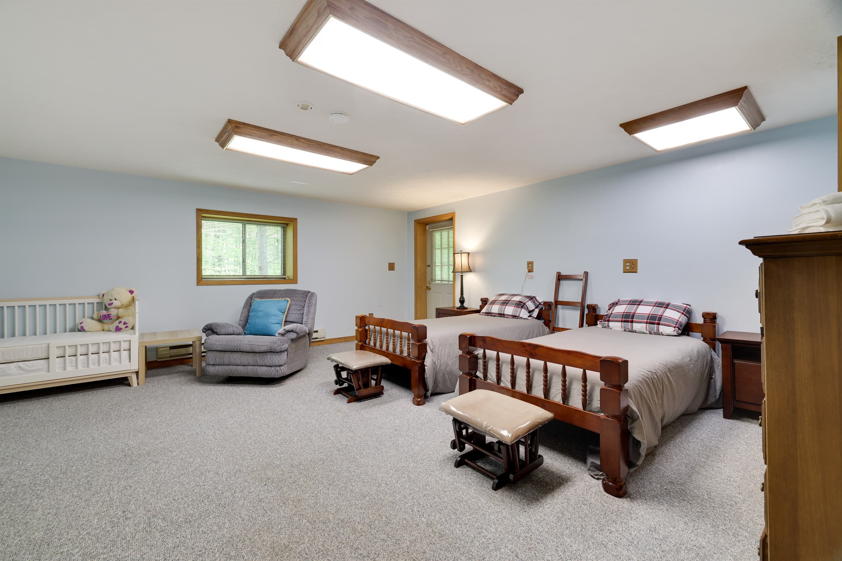 bedroom with two twin beds and a crib