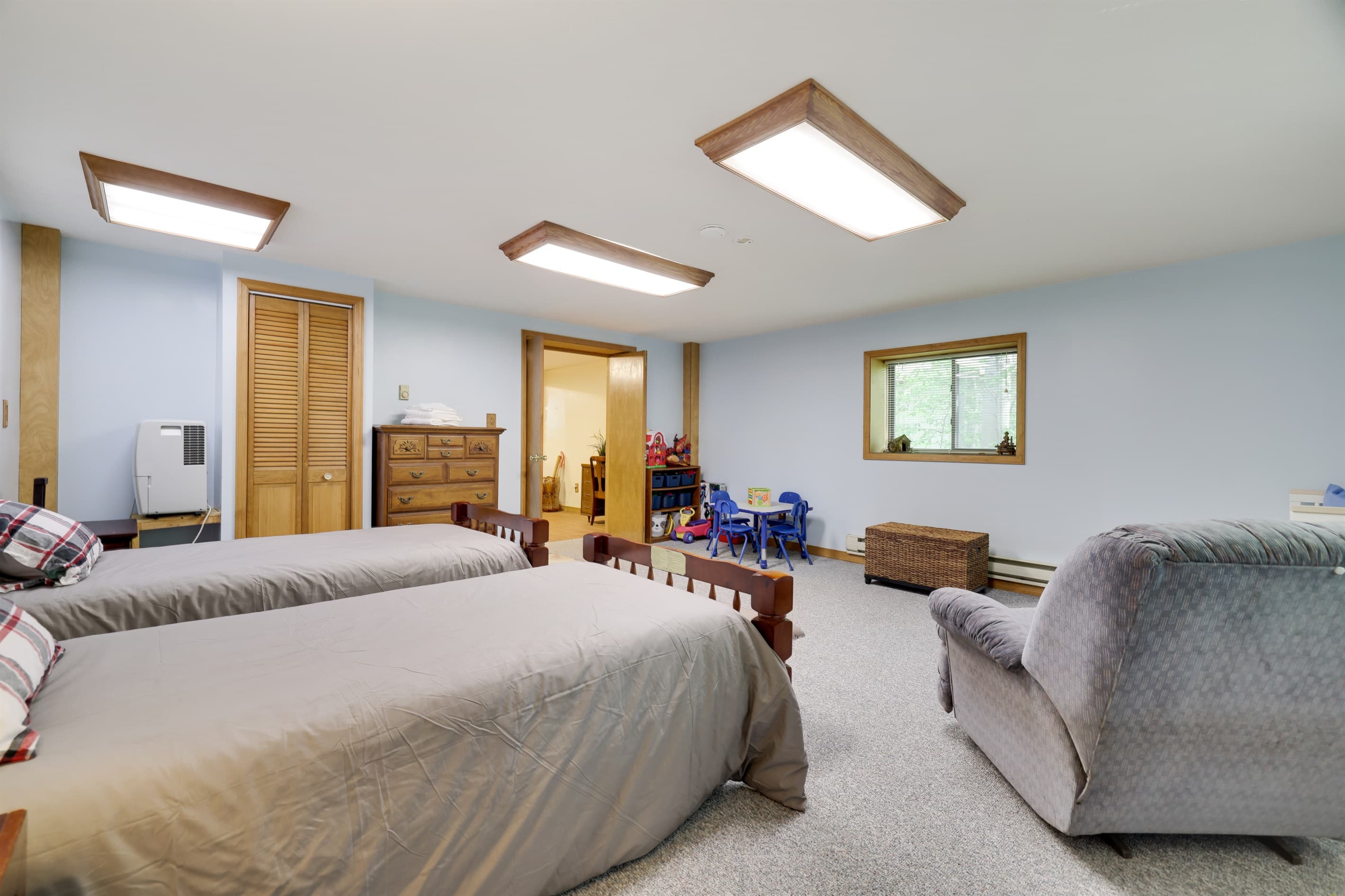 bedroom with two twin beds and a crib