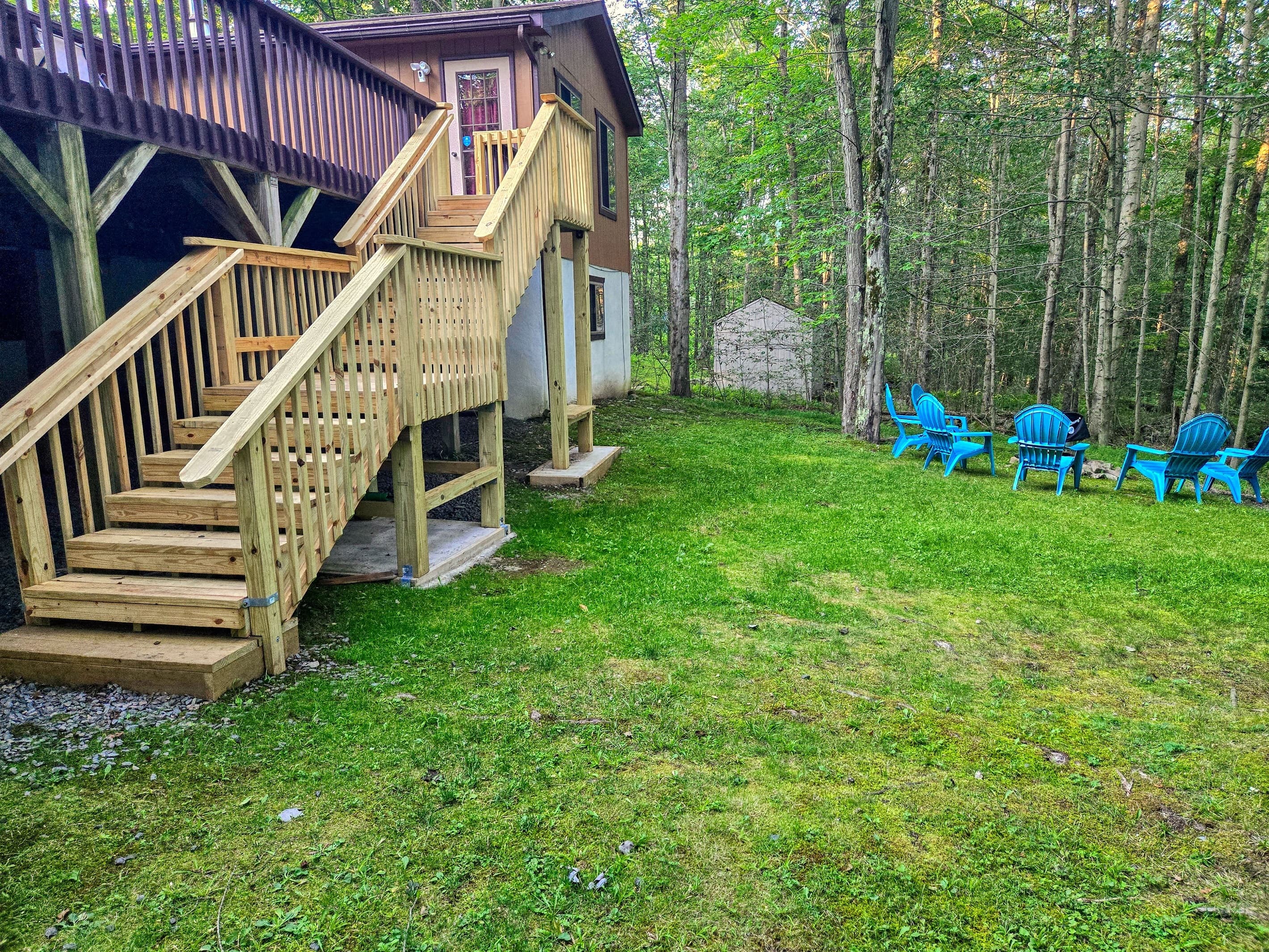 Backyard with firepit, stairs to the deck