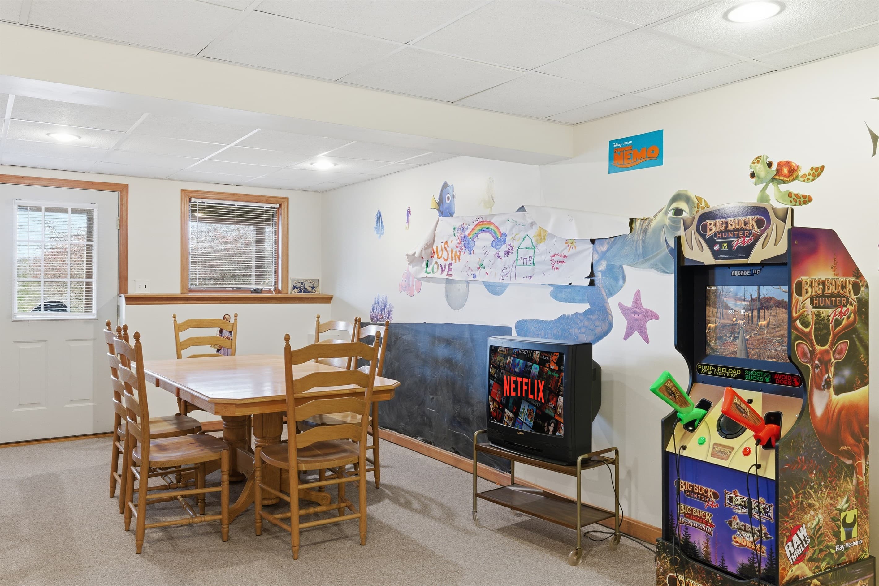 Playroom for kids and adults.  Air hockey, stereo system, toys, arcade, seating area.
