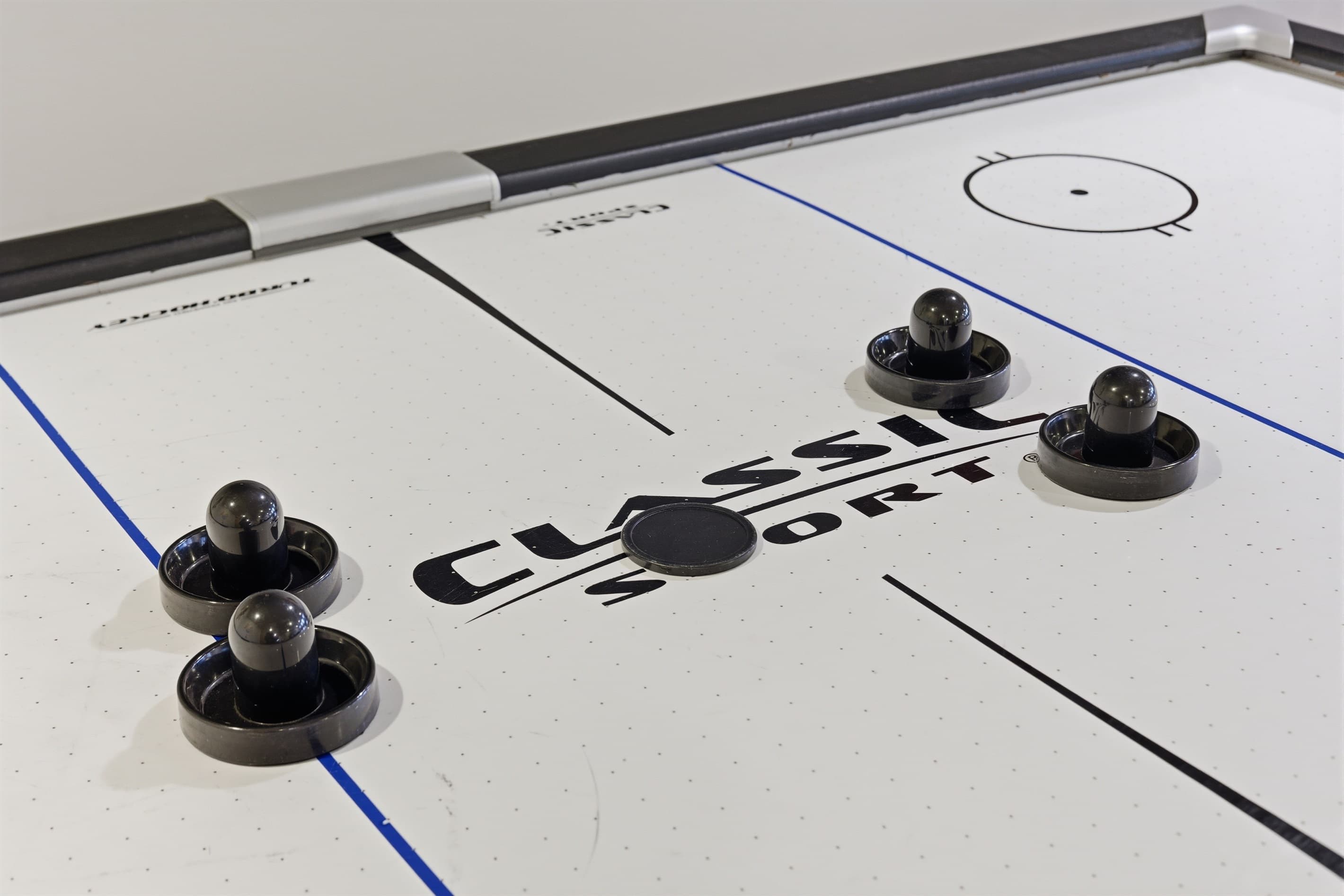 Playroom for kids and adults.  Air hockey, stereo system, toys, arcade, seating area.