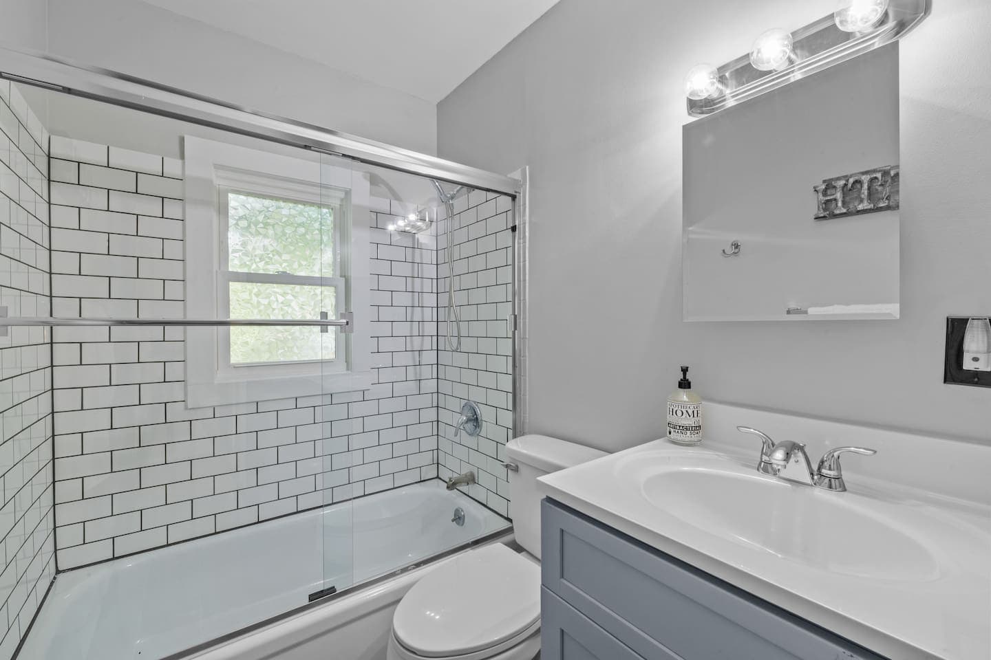 Unwind in the tub or enjoy a hot shower in this stylish, tiled space