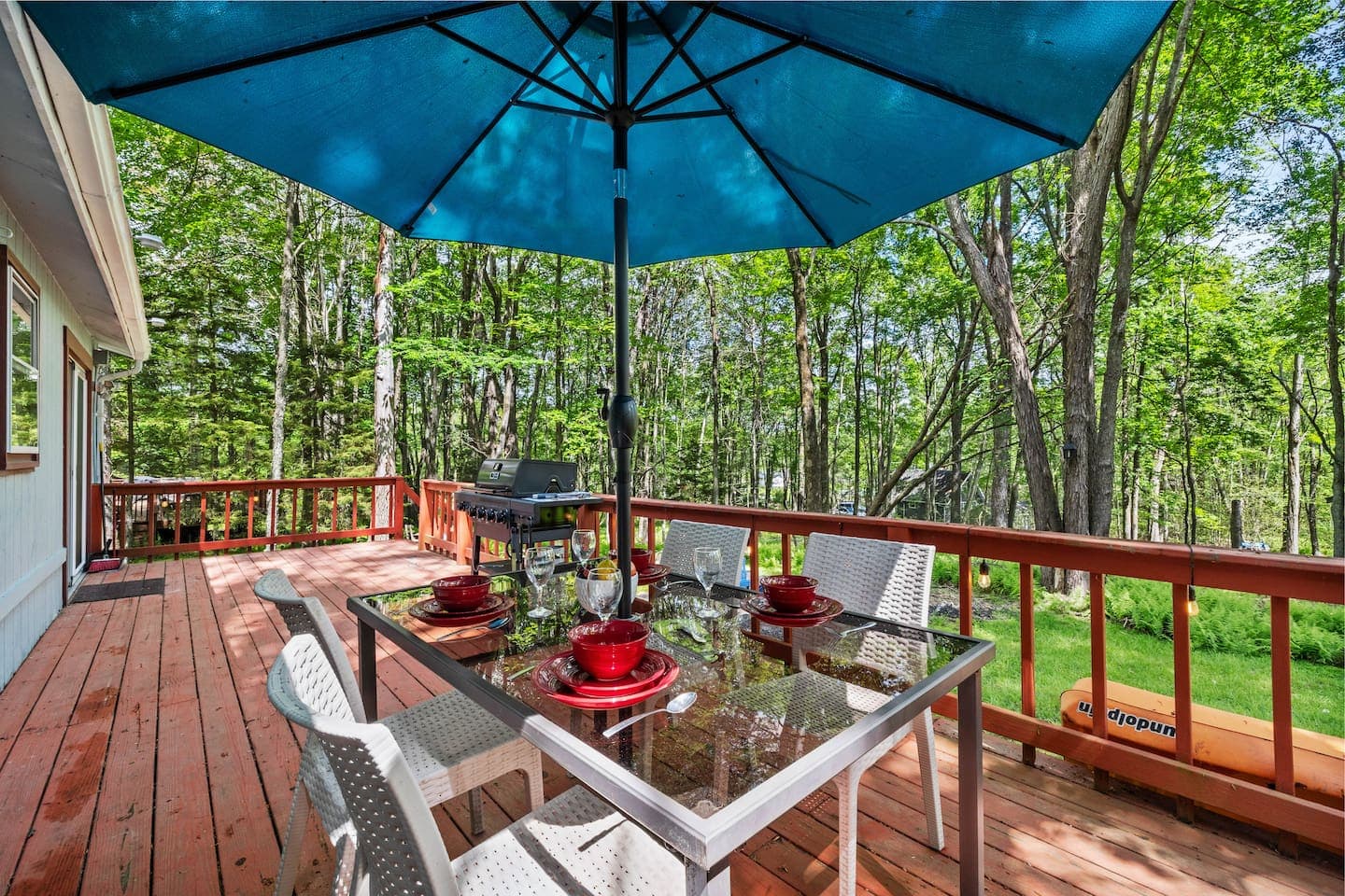Spacious deck with dining table and propane grill—perfect for outdoor meals