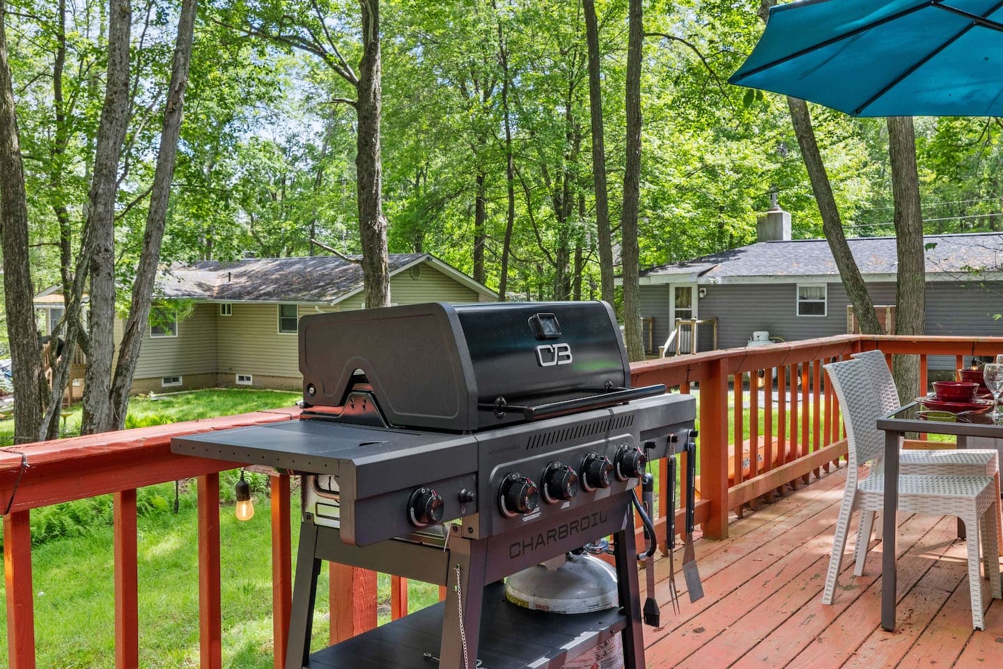 Spacious deck with dining table and propane grill—perfect for outdoor meals