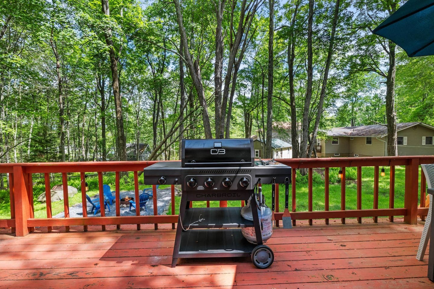 Spacious deck with dining table and propane grill—perfect for outdoor meals