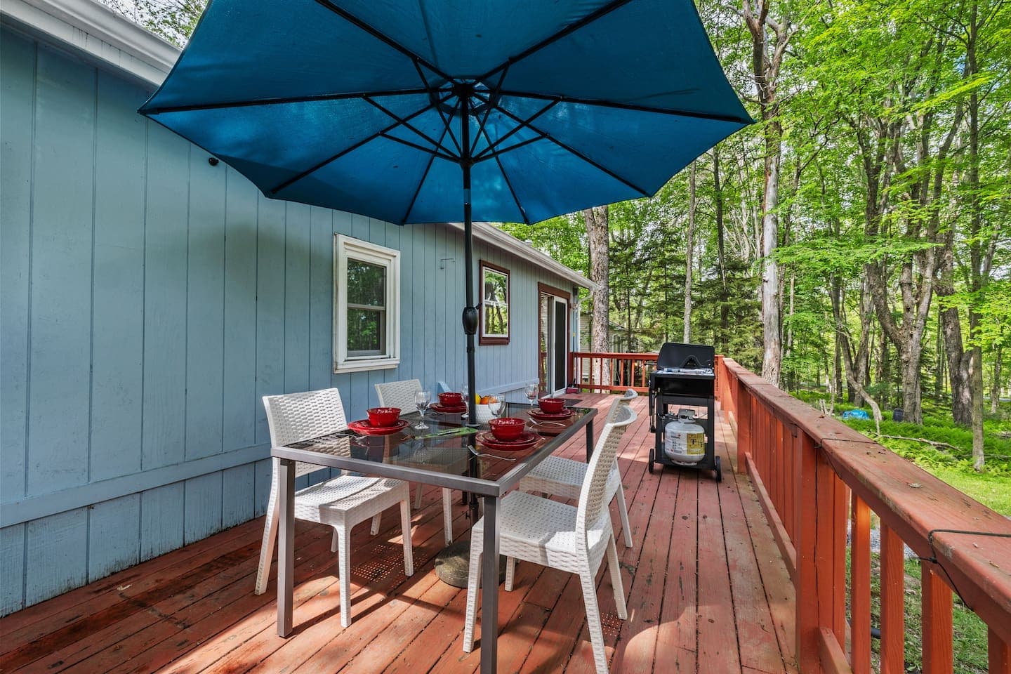 Spacious deck with dining table and propane grill—perfect for outdoor meals
