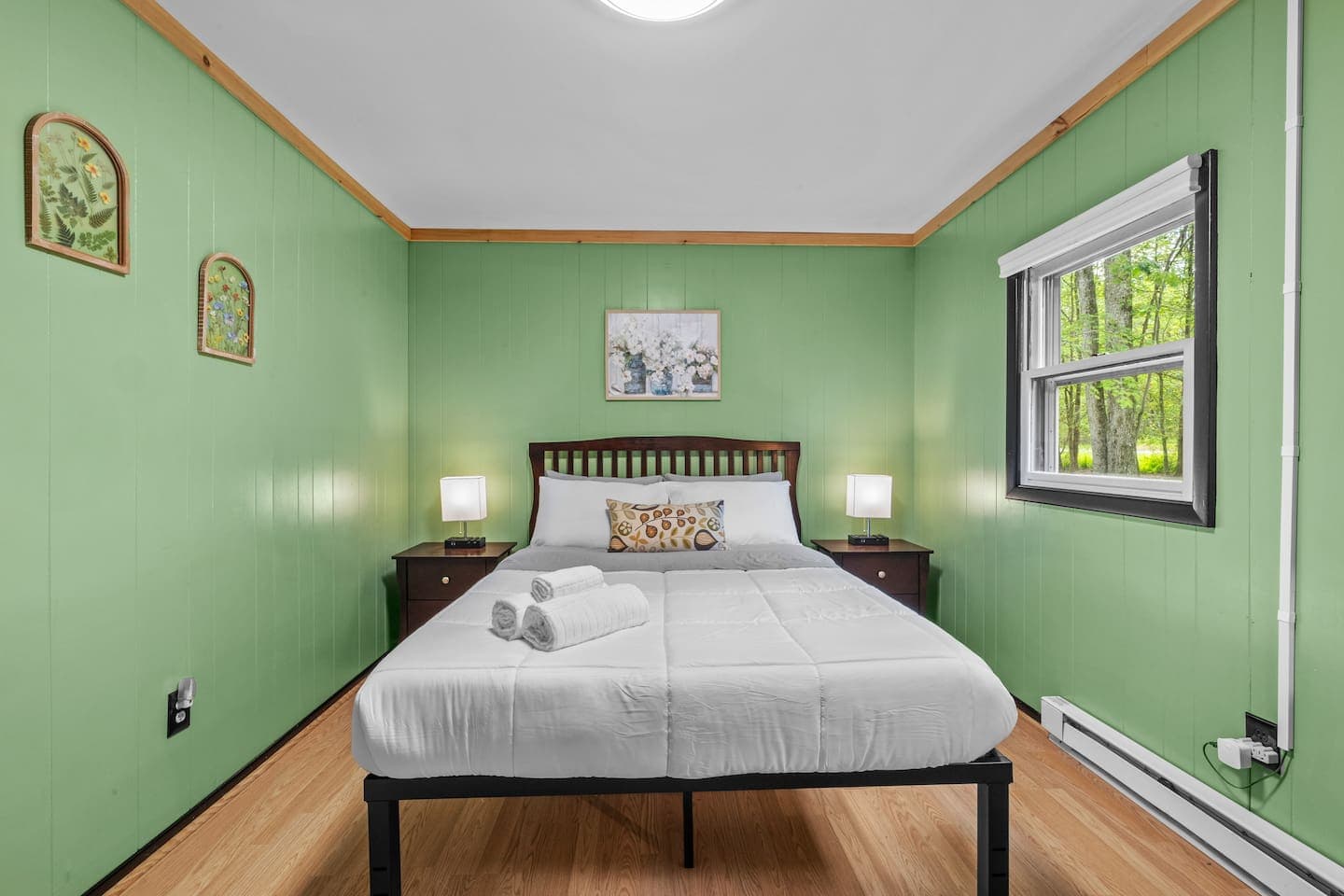 Rest easy in this cozy bedroom featuring a queen bed and mirrored dresser.