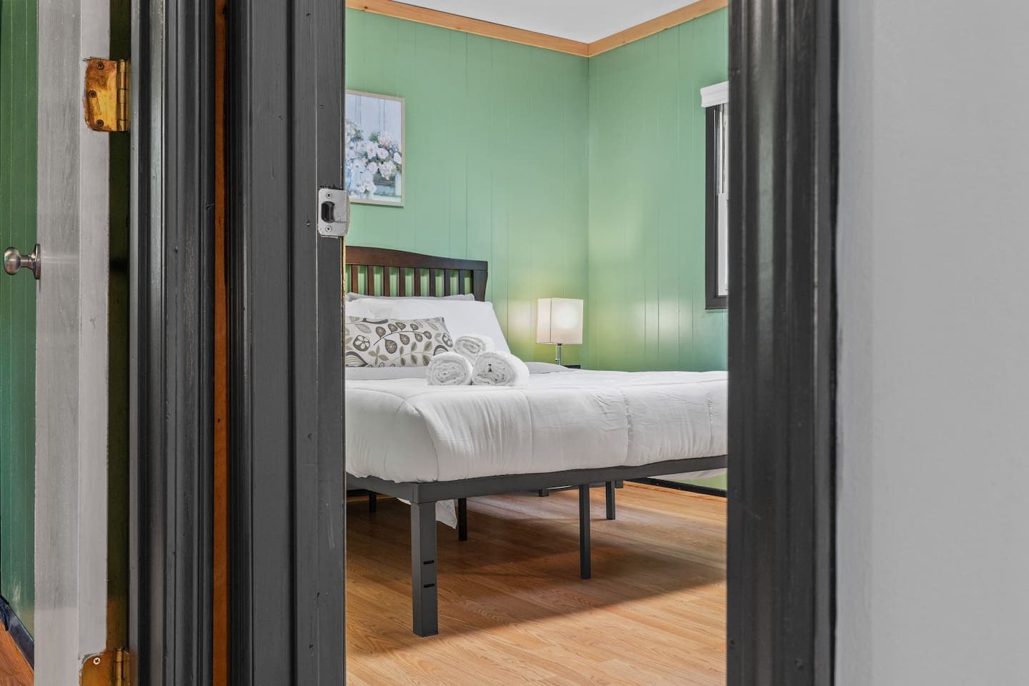 Rest easy in this cozy bedroom featuring a queen bed and mirrored dresser.
