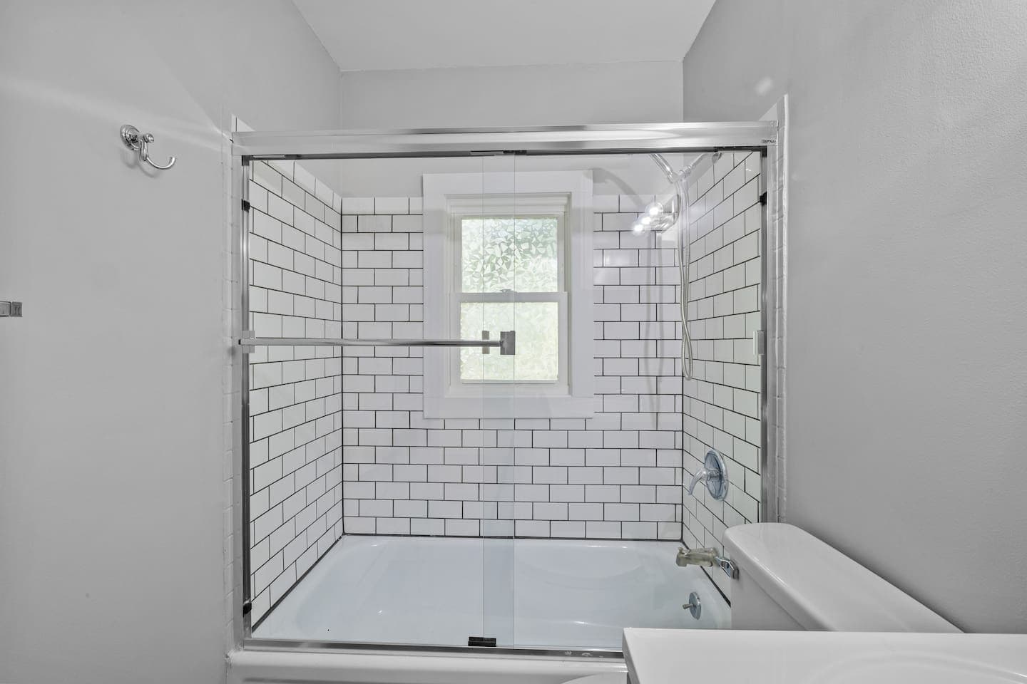 Unwind in the tub or enjoy a hot shower in this stylish, tiled space