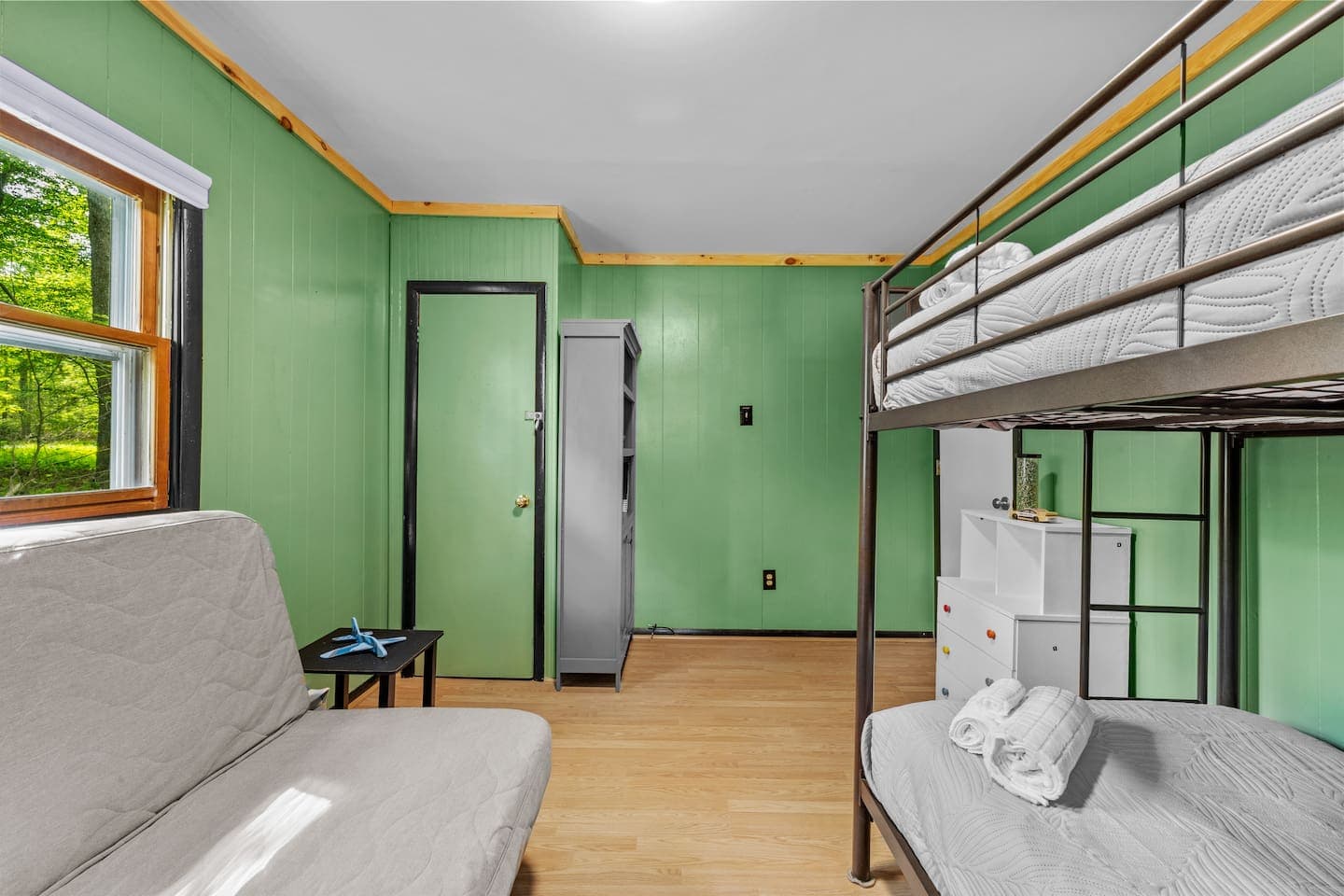 Kid-friendly room with a twin bunk bed and a full-size futon for extra sleeping space