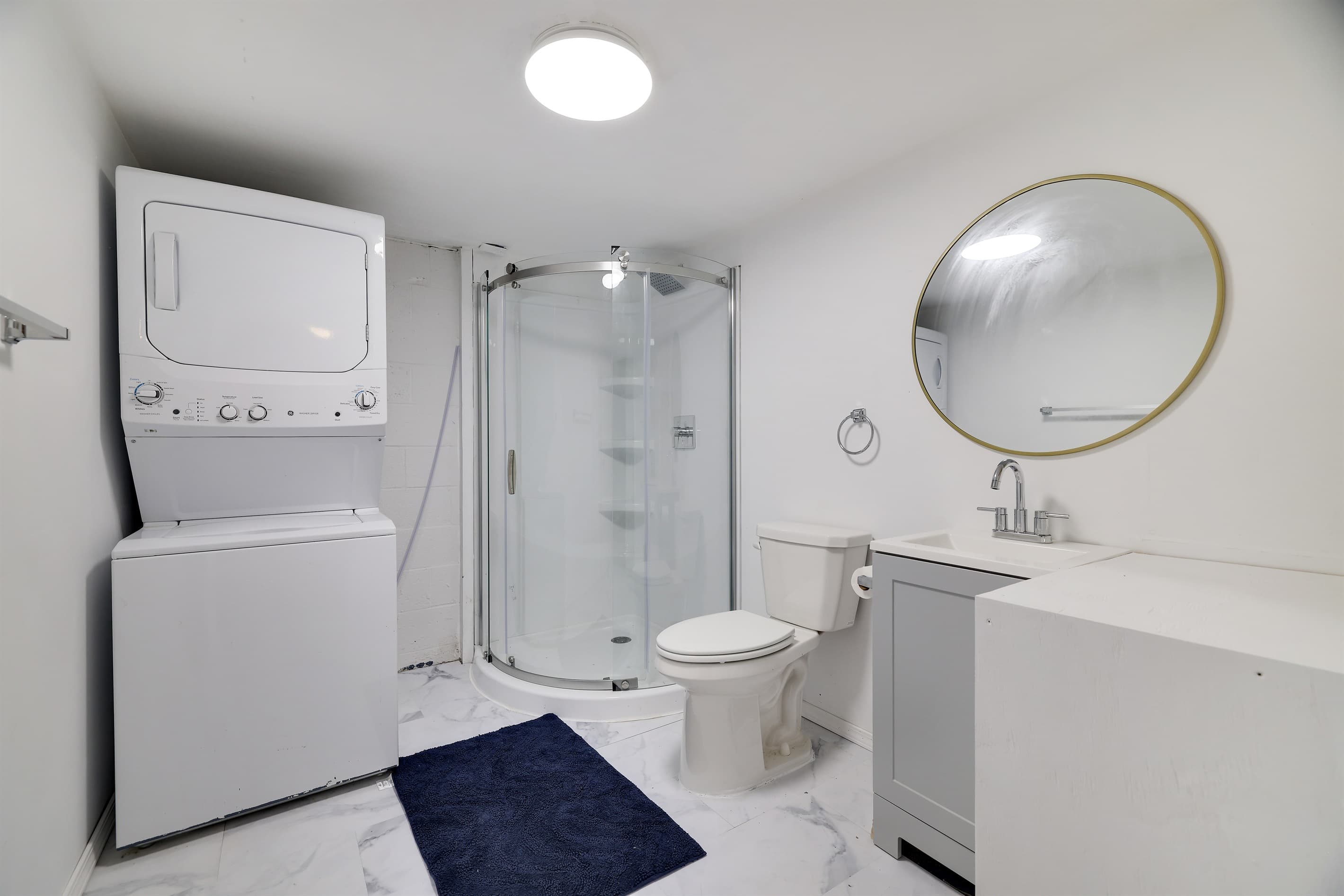 Lower level bathroom with washer and dryer
